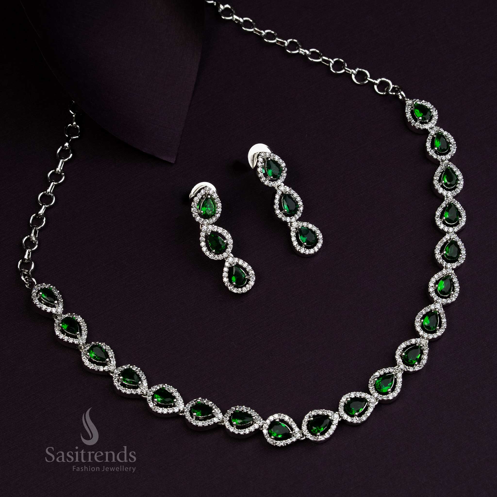 Graceful Thilak design jewellery set with emerald green American Diamond stones, rhodium silver plated, offering fusion style accents for ethnic and modern wear - Sasitrends