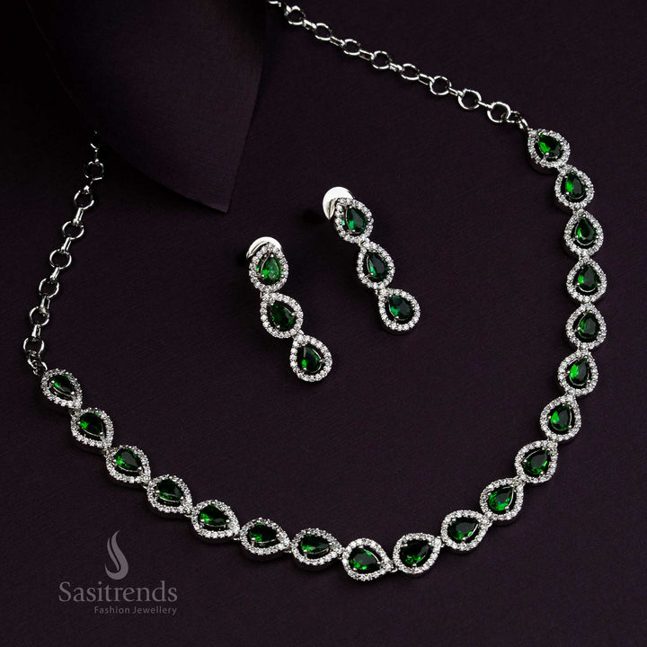 Graceful Thilak design jewellery set with emerald green American Diamond stones, rhodium silver plated, offering fusion style accents for ethnic and modern wear - Sasitrends