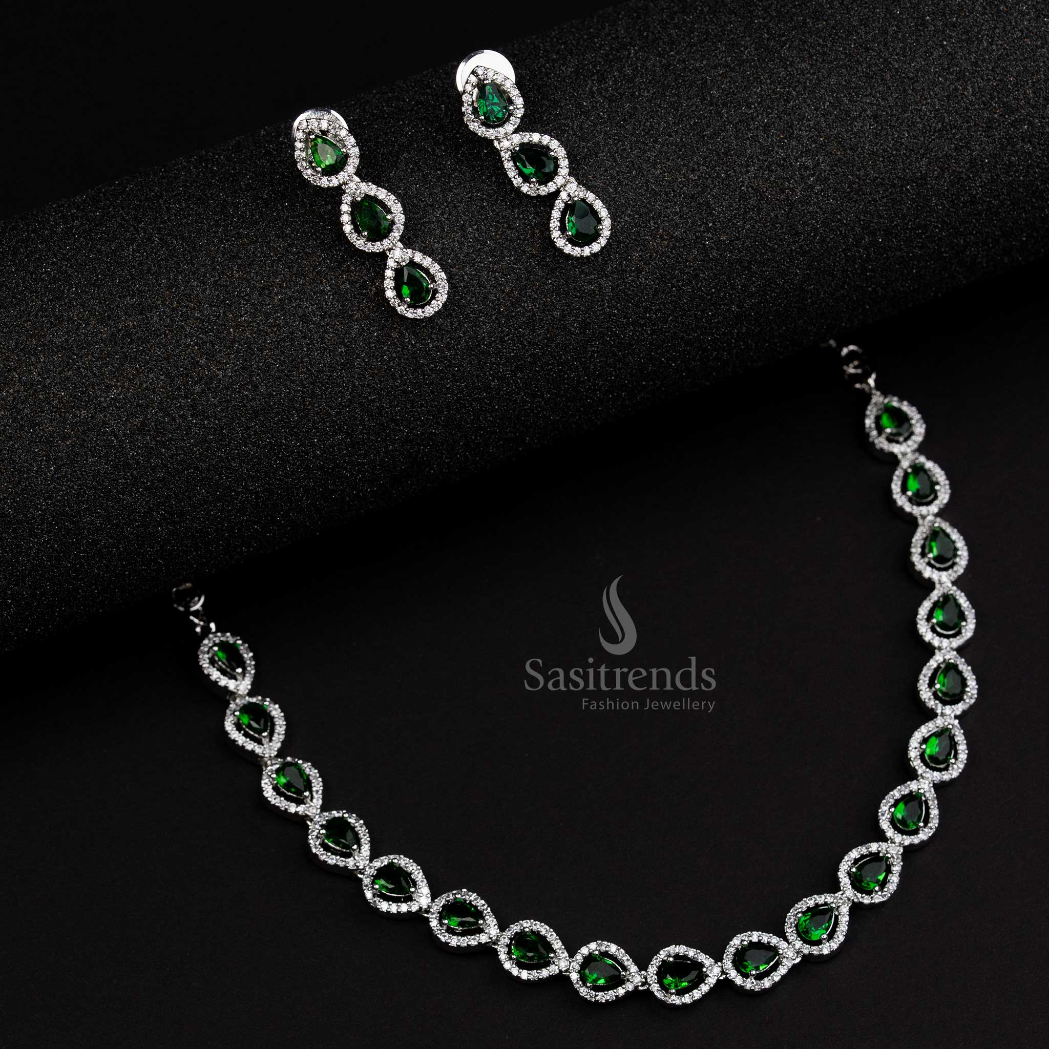 Elegant green American Diamond Thilak pattern jewellery set in rhodium silver plating, a stunning party wear design crafted for timeless sophistication - Sasitrends