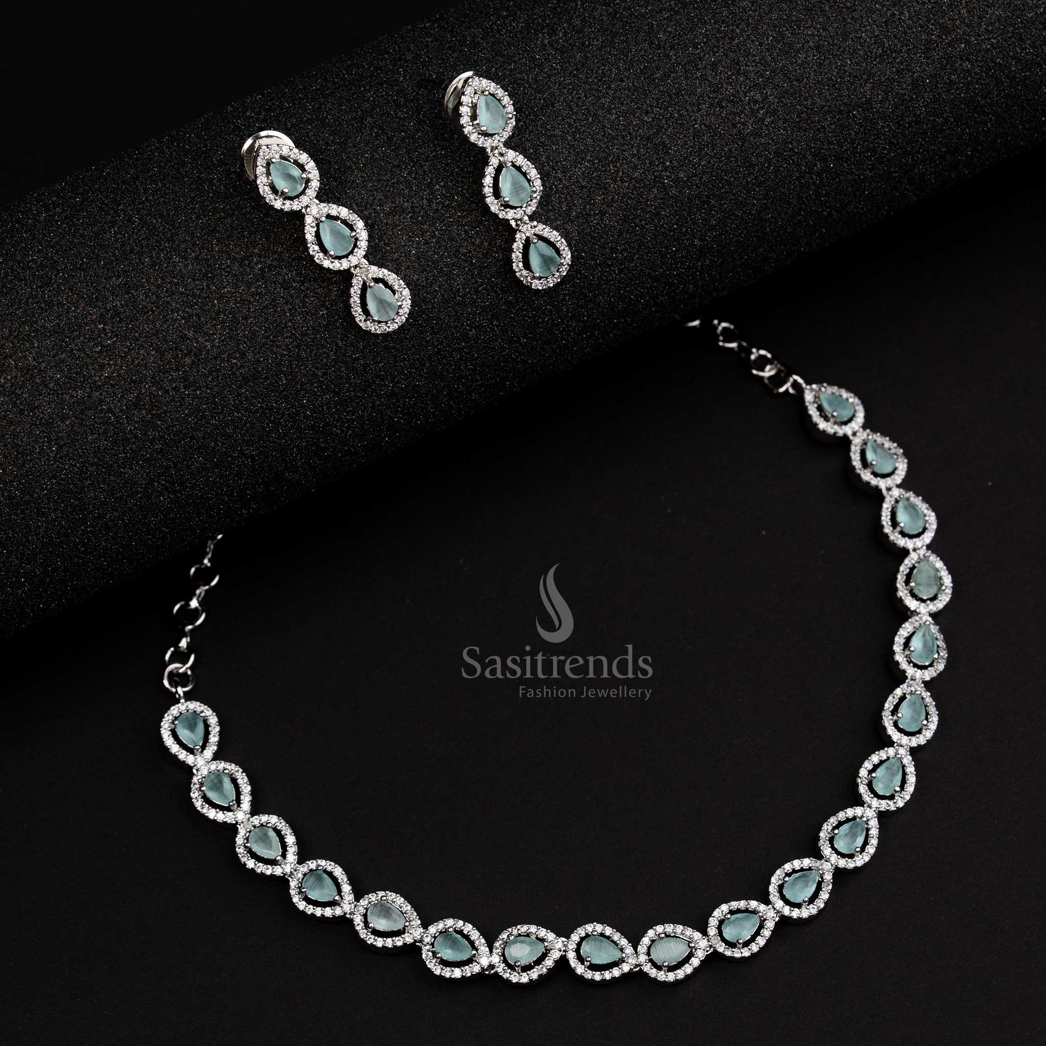 Graceful rhodium silver plated jewellery set with soft mint stones and intricate Thilak design, a delicate choice for elegant festive occasions - Sasitrends
