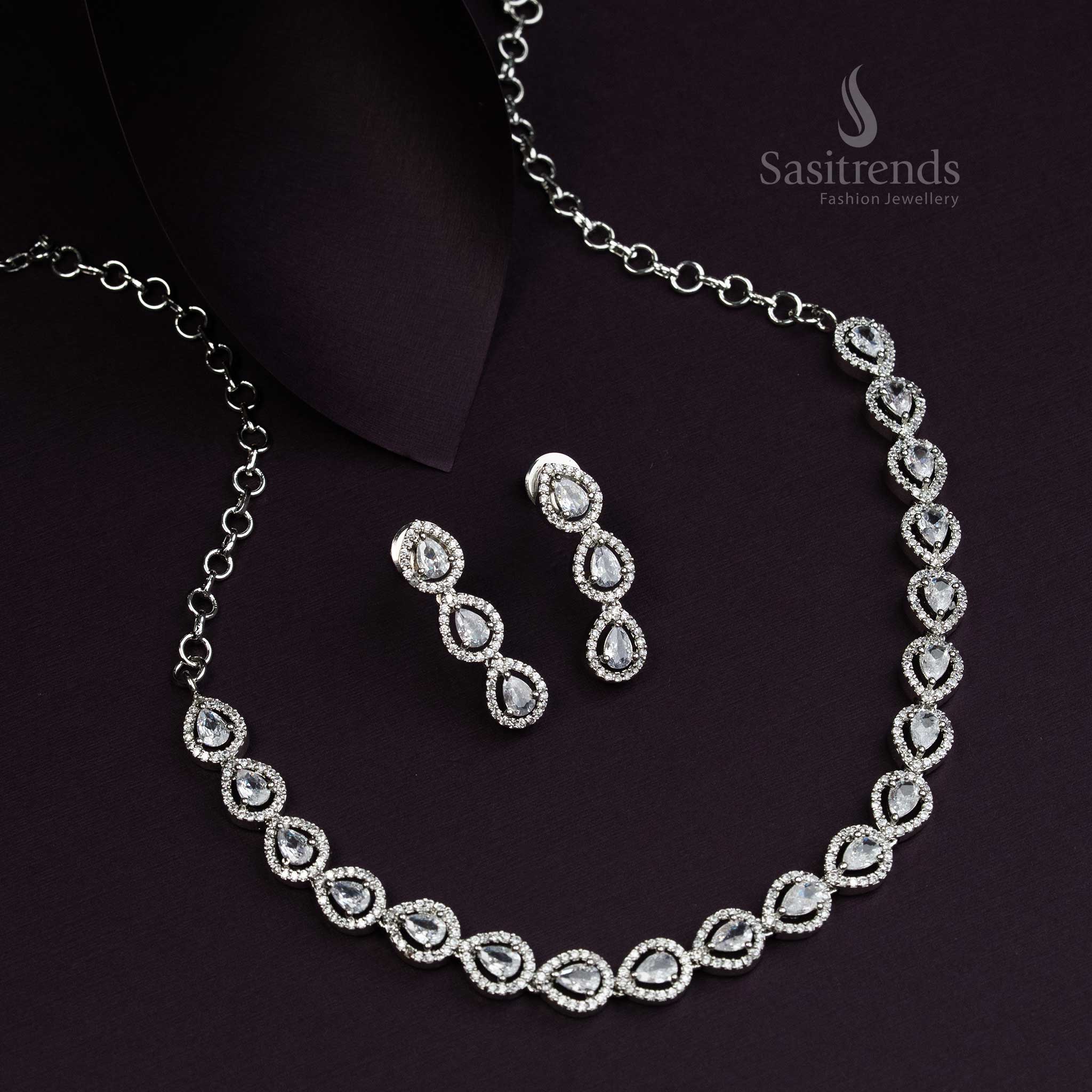 Elegant Thilak pattern rhodium silver plated jewellery set adorned with pristine white American Diamond stones, an opulent party wear design for graceful evening looks - Sasitrends