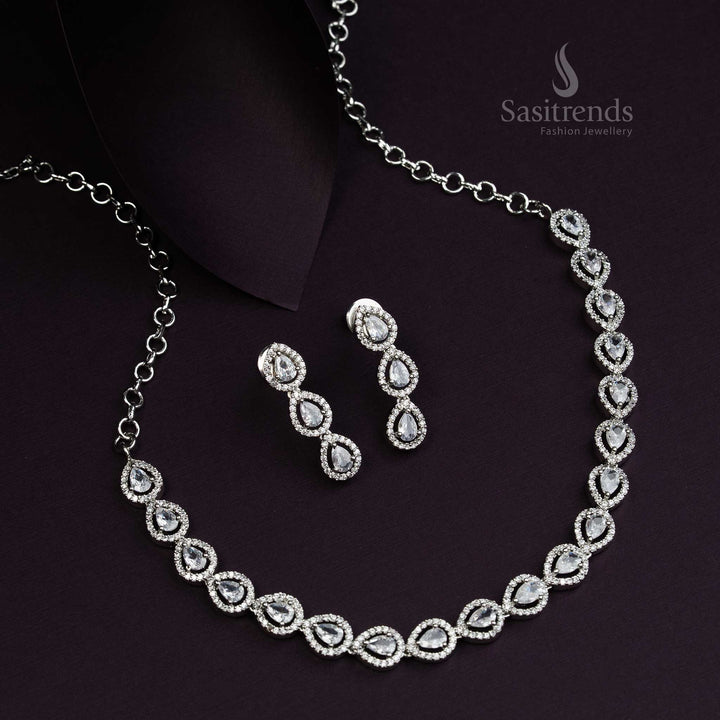 Elegant Thilak pattern rhodium silver plated jewellery set adorned with pristine white American Diamond stones, an opulent party wear design for graceful evening looks - Sasitrends