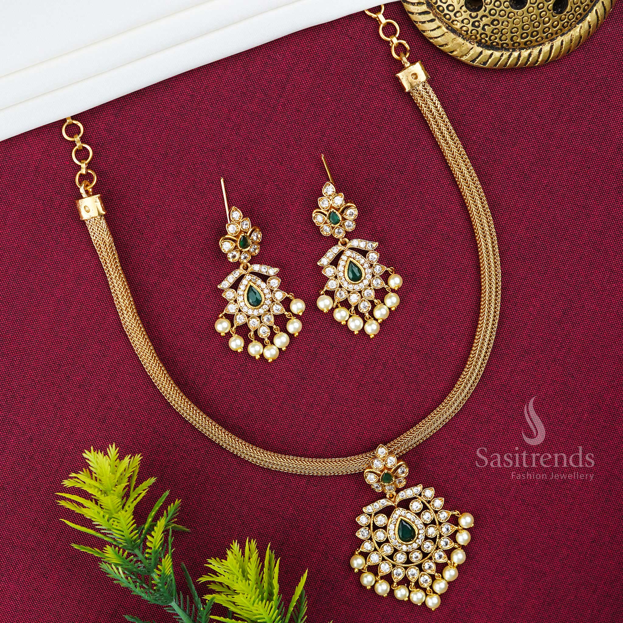 Center Green Kemp Stone Temple Style Floral Pendant Jewellery Set In Matte Gold Tone With Jhumkas And Chain – A Vibrant Leafy Look Inspired By Nature And Culture, Ideal For Traditional Saree Styling – Sasitrends