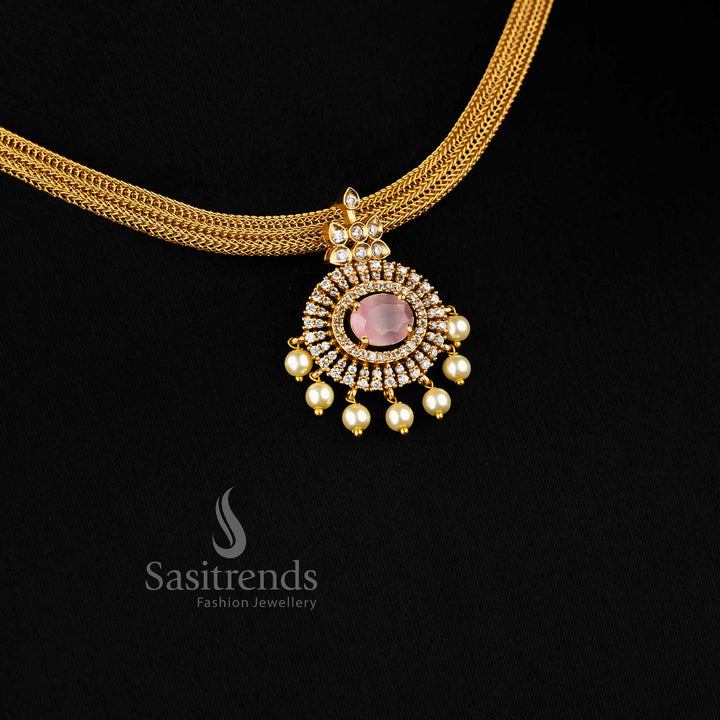 Elegant pink Attigai choker with temple-style floral pendant and matte gold finish – ideal for festive saree looks – Sasitrends