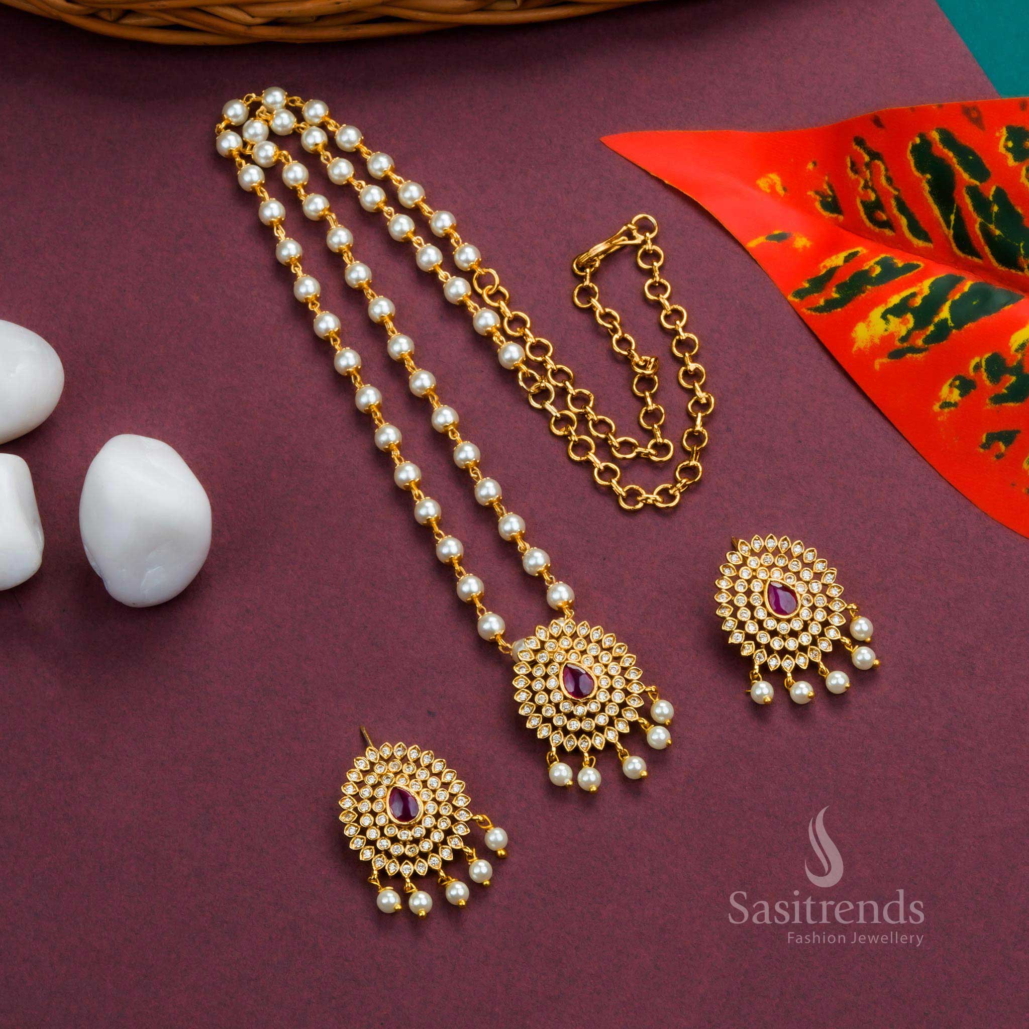 Graceful Temple White Ruby Pearl Jewellery Set With Matte Gold Floral Pendant And Droplet Pearl Hangings – A Divine Design With Sparkling AD Stones, Ruby Highlights, And Traditional Craftsmanship – Sasitrends