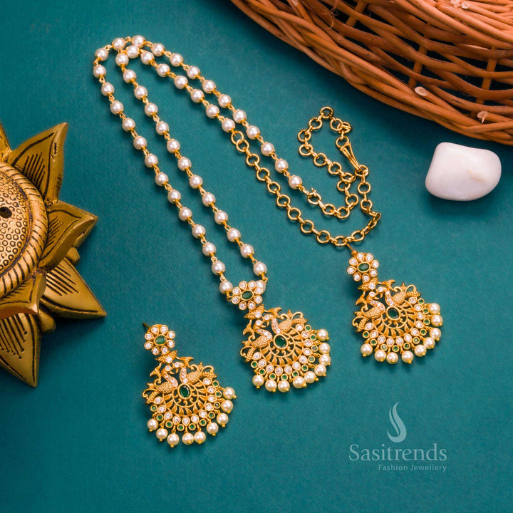 Elegant Matte Gold Temple White Green Peacock Pendant Pearl Jewellery Set With AD Stones And Traditional Finesse – A Serene Mix Of White-Green Sparkle Accentuated With Temple-Inspired Peacock Motif And Delicate Pearls – Sasitrends