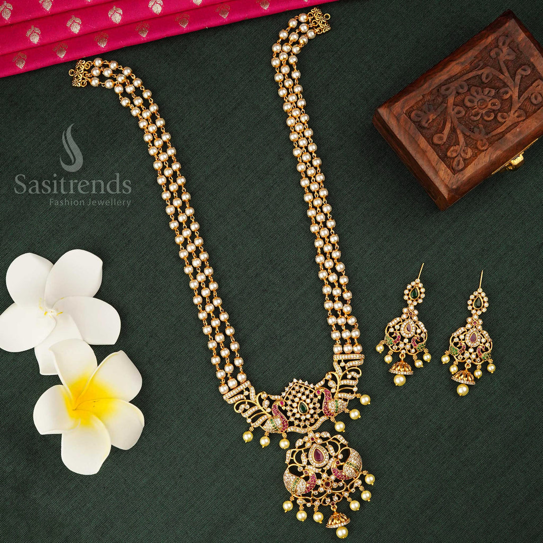 Temple matte gold plated pearl mala jewellery set with a graceful three-strand layout and a regal peacock pendant enriched with pearl detailing – a heritage-inspired masterpiece ideal for South Indian bridal elegance and cultural occasions – Sasitrends