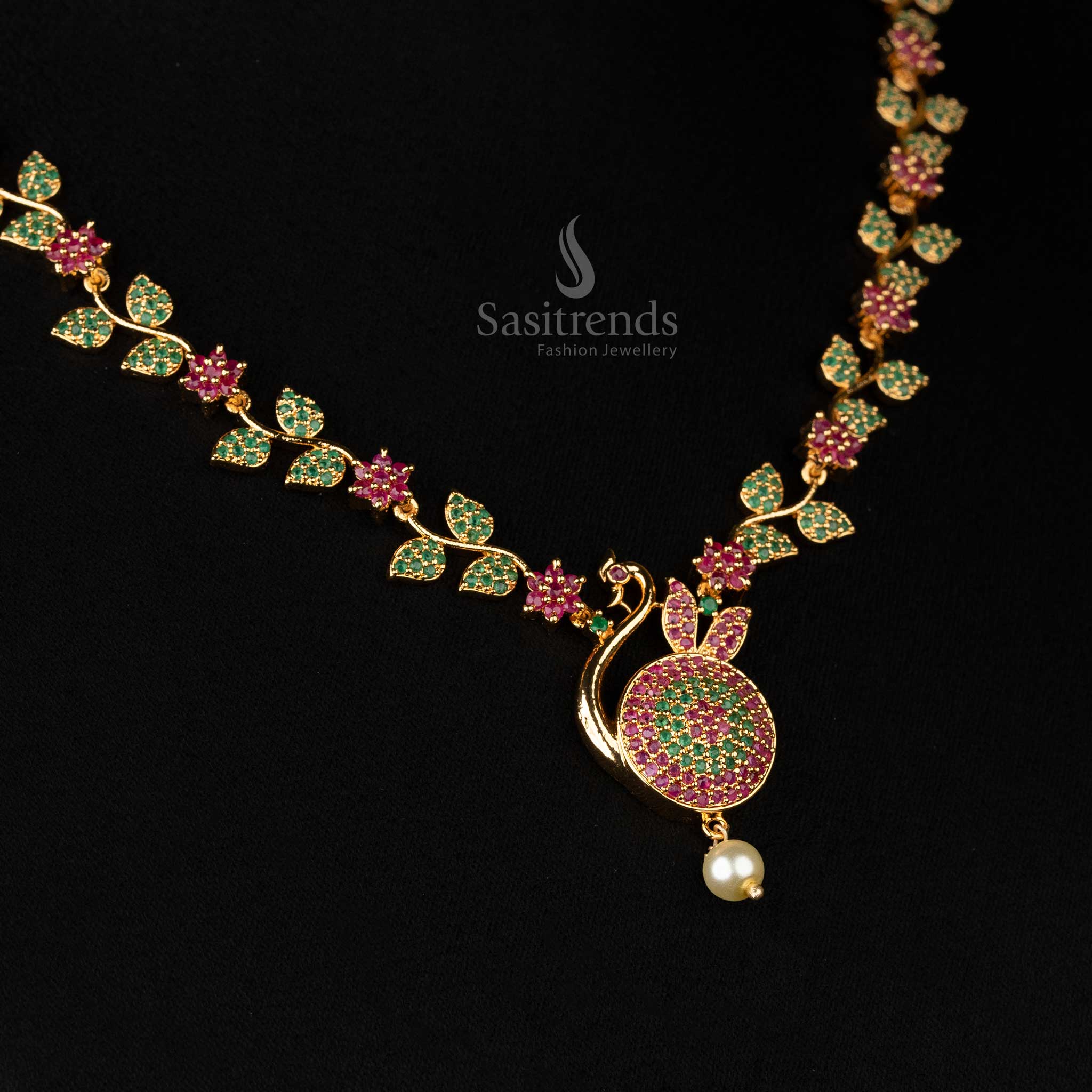 Detailed view of peacock motif pendant in micro gold with a shimmering pearl accent  - Sasitrends