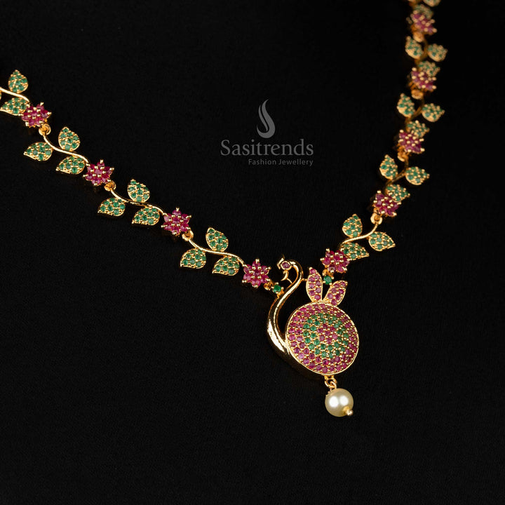 Detailed view of peacock motif pendant in micro gold with a shimmering pearl accent  - Sasitrends