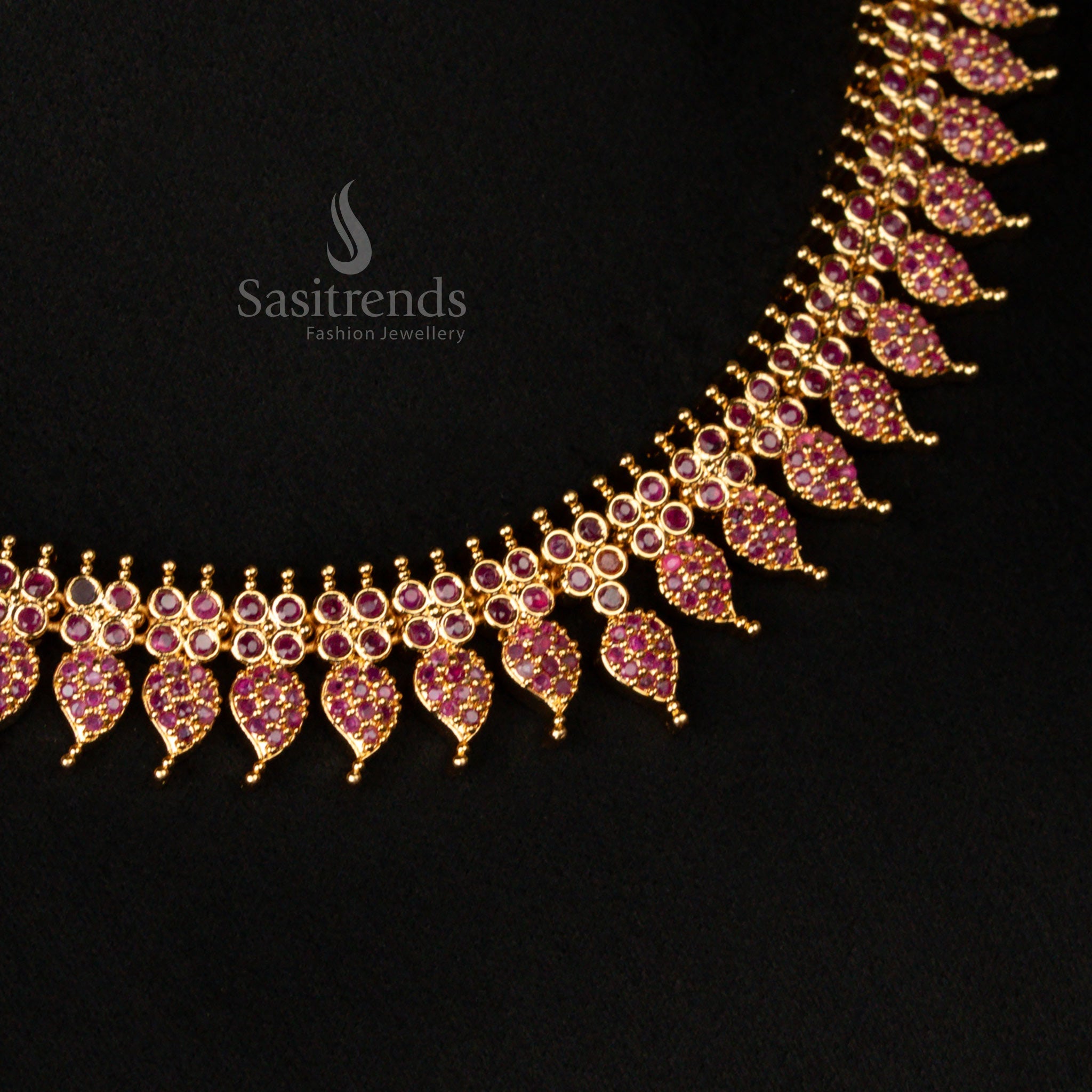Grand micro gold plated leaf motif necklace jewellery set, embellished with deep ruby stones and shimmering American diamonds, perfect for weddings and cultural events - Sasitrends
