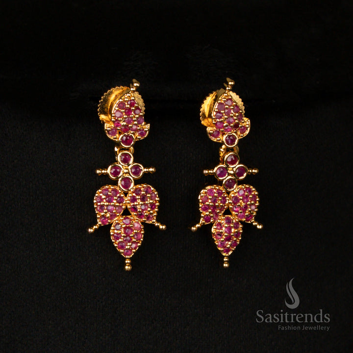 Exquisite micro gold finish earrings set with intricate leaf patterns, adorned with radiant ruby stones and sparkling American diamonds for a regal ethnic look - Sasitrends
