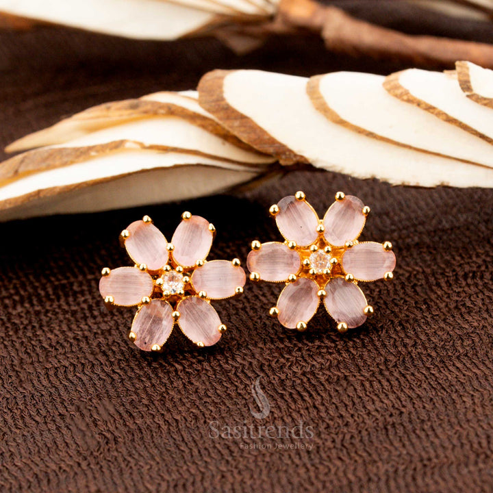 Elegant gold-plated floral stud earrings adorned with sparkling pink American diamond stones, a perfect accessory for party wear, bridal ensembles, and grand ethnic occasions - Sasitrends