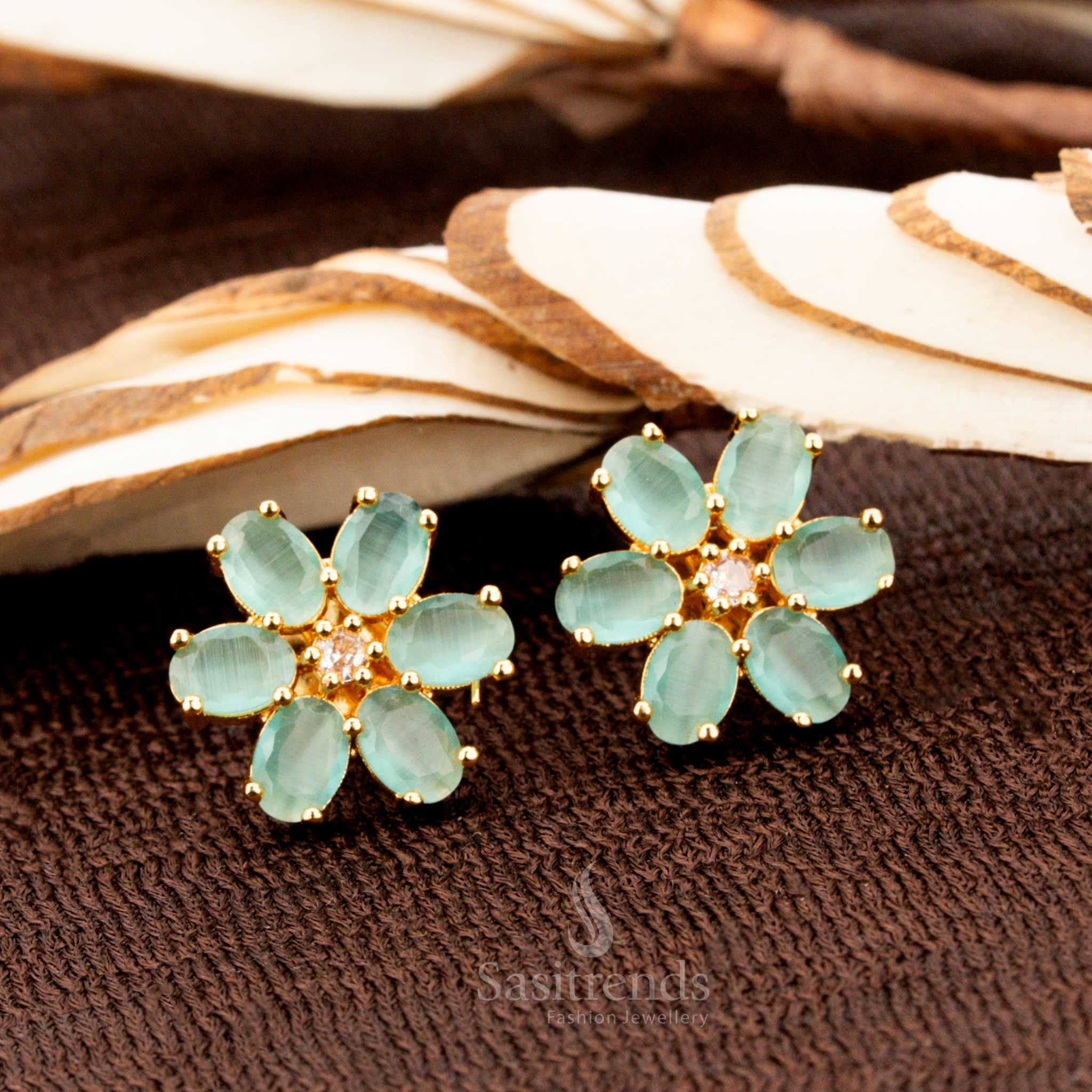Charming gold-plated floral stud earrings adorned with mint American diamond stones, a beautiful addition to traditional attire, sarees, and grand ethnic celebrations - Sasitrends