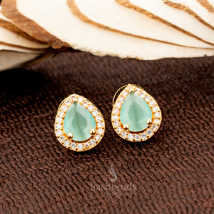 Charming gold-plated American diamond oval stud earrings with refreshing mint stones, a stylish jewellery choice for festive occasions, saree styling, and modern ethnic fashion - Sasitrends