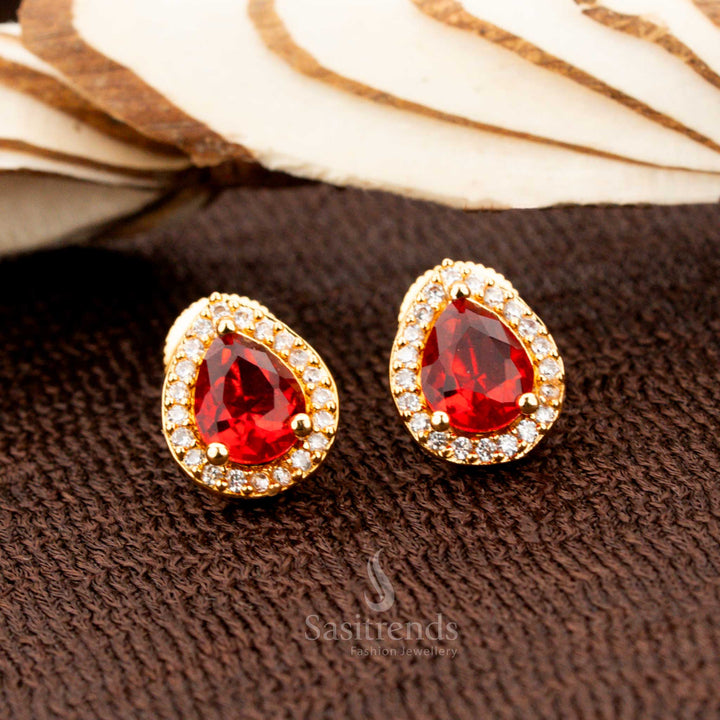 Elegant gold-plated American diamond oval stud earrings featuring ravishing red stones, a perfect bridal and festive jewellery piece for sarees and ethnic attire - Sasitrends