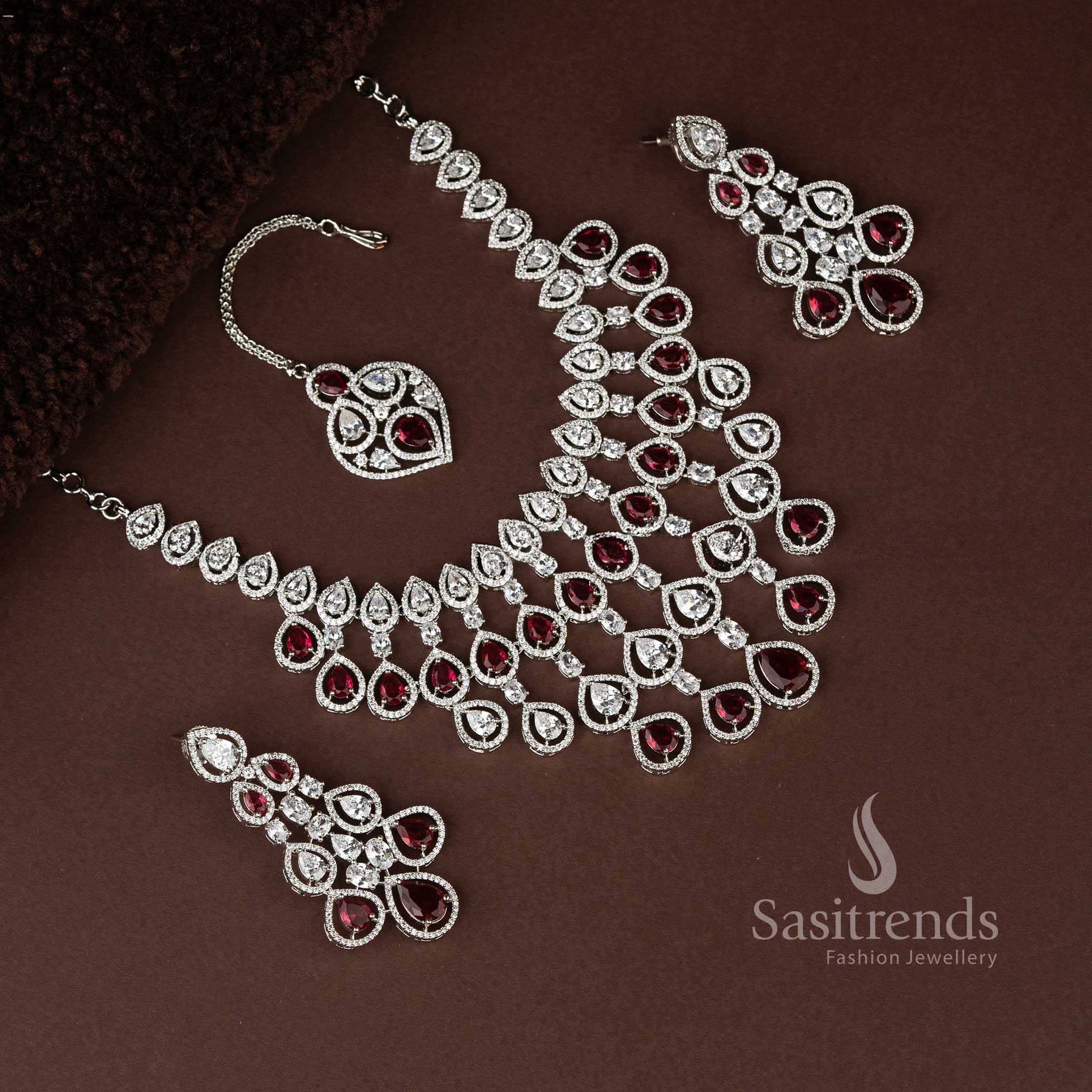 Luxurious red bridal jewellery ensemble in rhodium plating, embellished with dazzling American diamonds for grand bridal occasions - Sasitrends