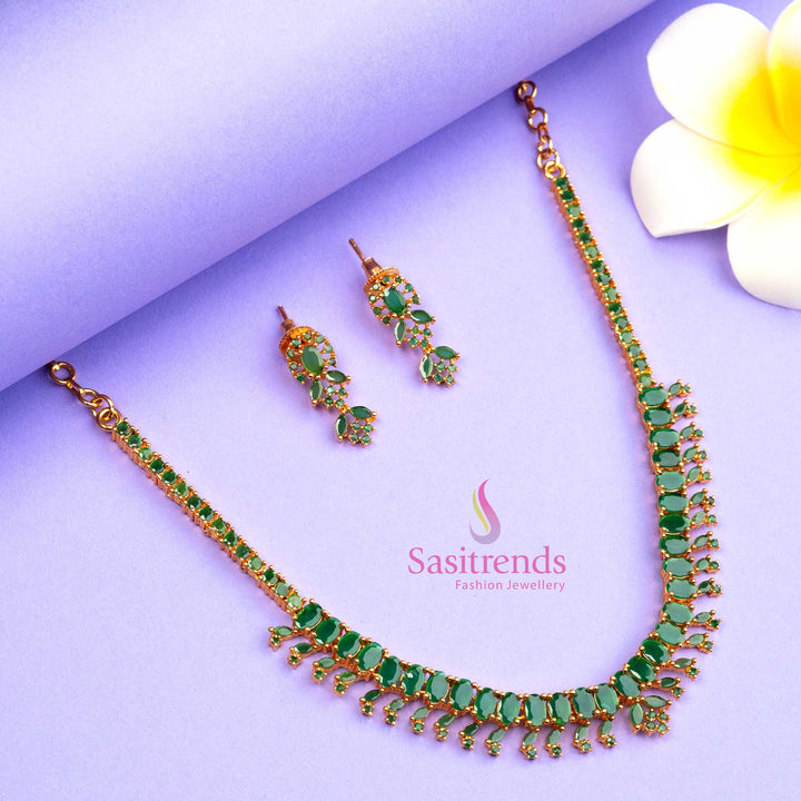 Elegant micro gold plated jewellery set with green stones and sparkling American Diamond highlights, a classic design ideal for party wear and ethnic wear - Sasitrends