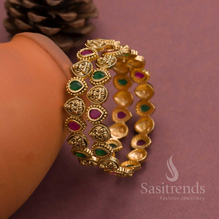 Grand temple matte gold plated bangles with Lakshmi deity engravings and alternating ruby-green thilak AD stones, ideal for bright festive jewellery and cultural bridal styling – sasitrends