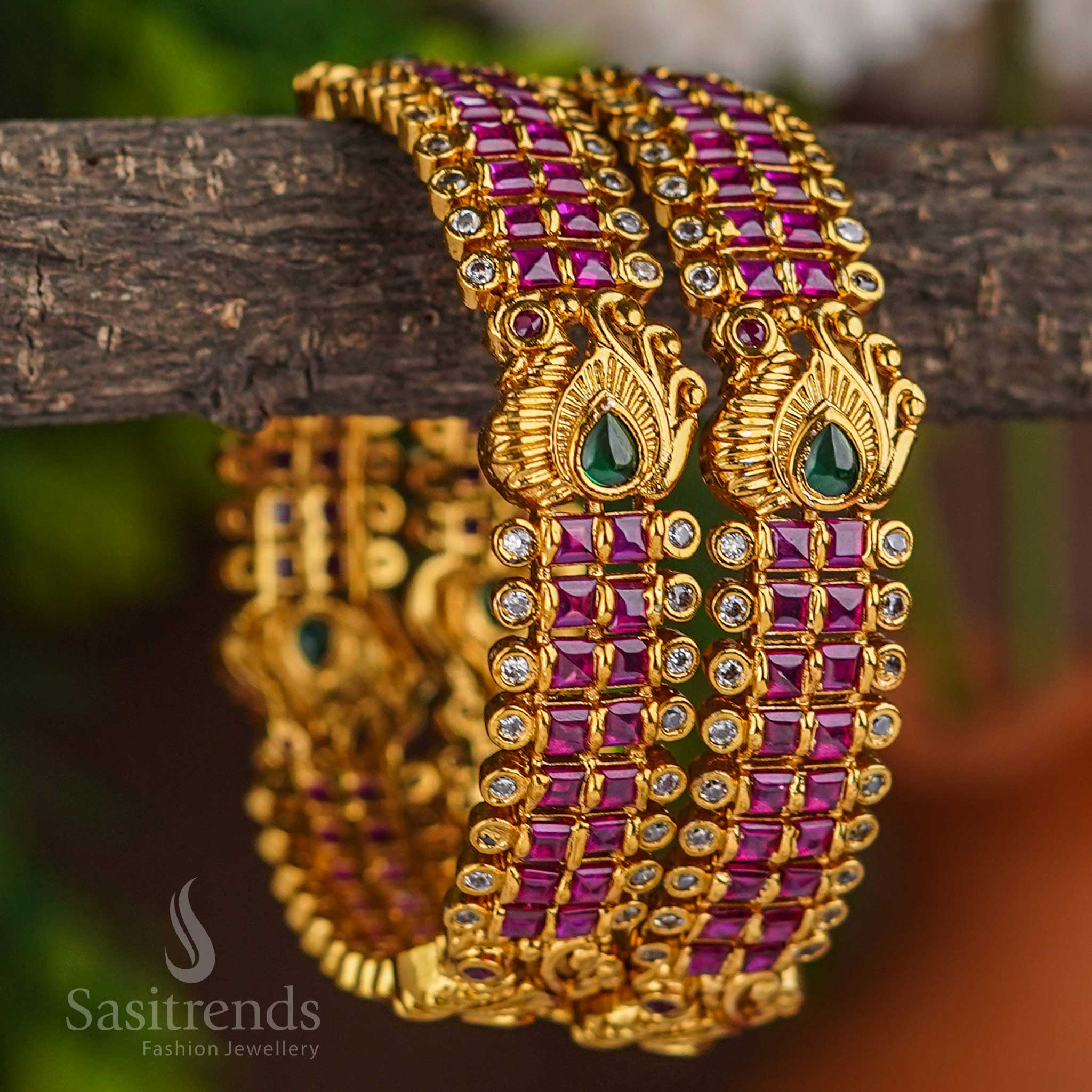 Exquisite ruby multi tone AD bridal bangles designed with majestic peacock motif and finished in temple matte gold plating for divine elegance on special wedding occasions - Sasitrends