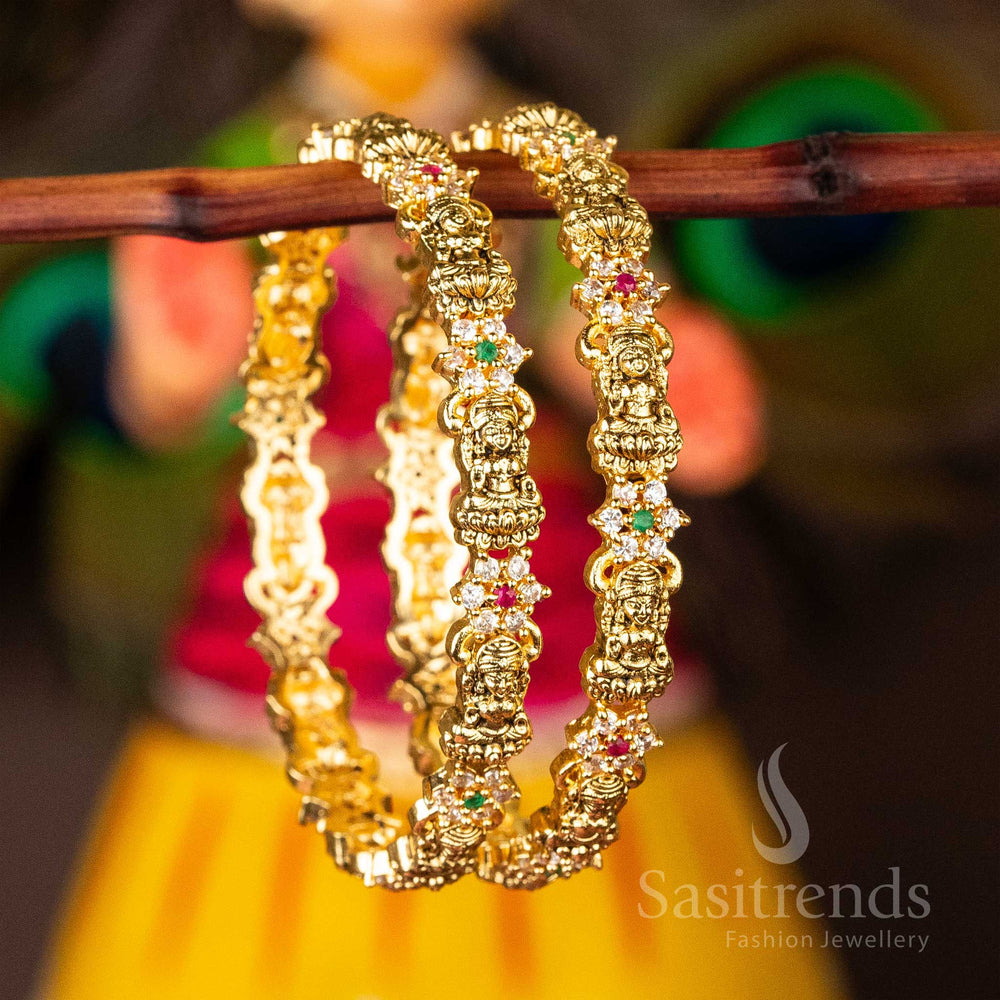 Lakshmi and flower engraved temple bangles in matte gold finish with colourful multi-stone accents, blending heritage elegance with ethnic charm – a captivating jewellery piece from Sasitrends