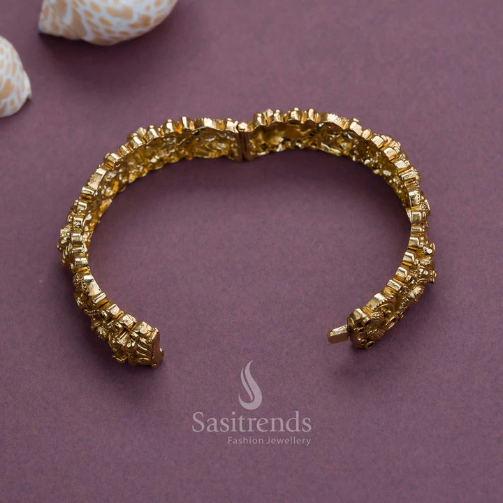Majestic matte gold finish kada bangle with ruby-green stones and divine Goddess Lakshmi motif in a temple-style openable design, perfect for sarees and festive occasions – Sasitrends