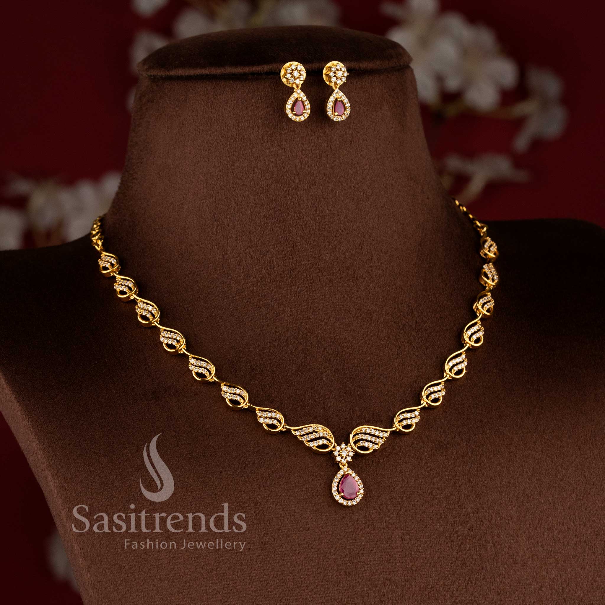 Party wear matte gold plated American Diamond necklace set with elegant leaf motif and water drop pendant design - Sasitrends.