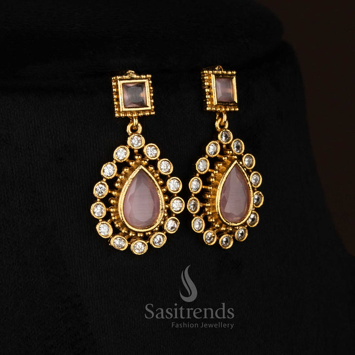 Charming pink American Diamond matte gold plated teardrop stone earrings designed for festive wear - Sasitrends