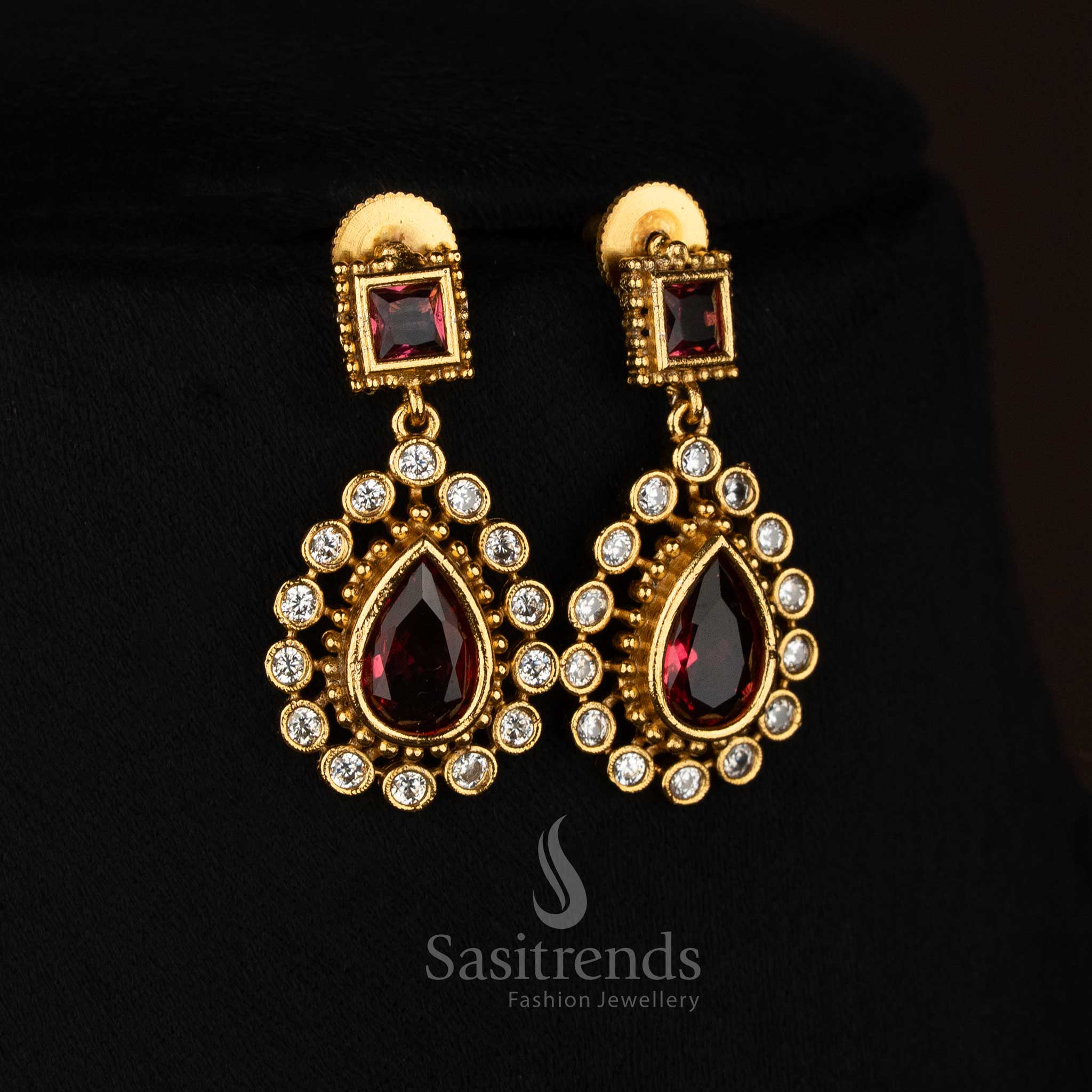 Attractive red American Diamond matte gold plated teardrop stone earrings ideal for festive occasions - Sasitrends