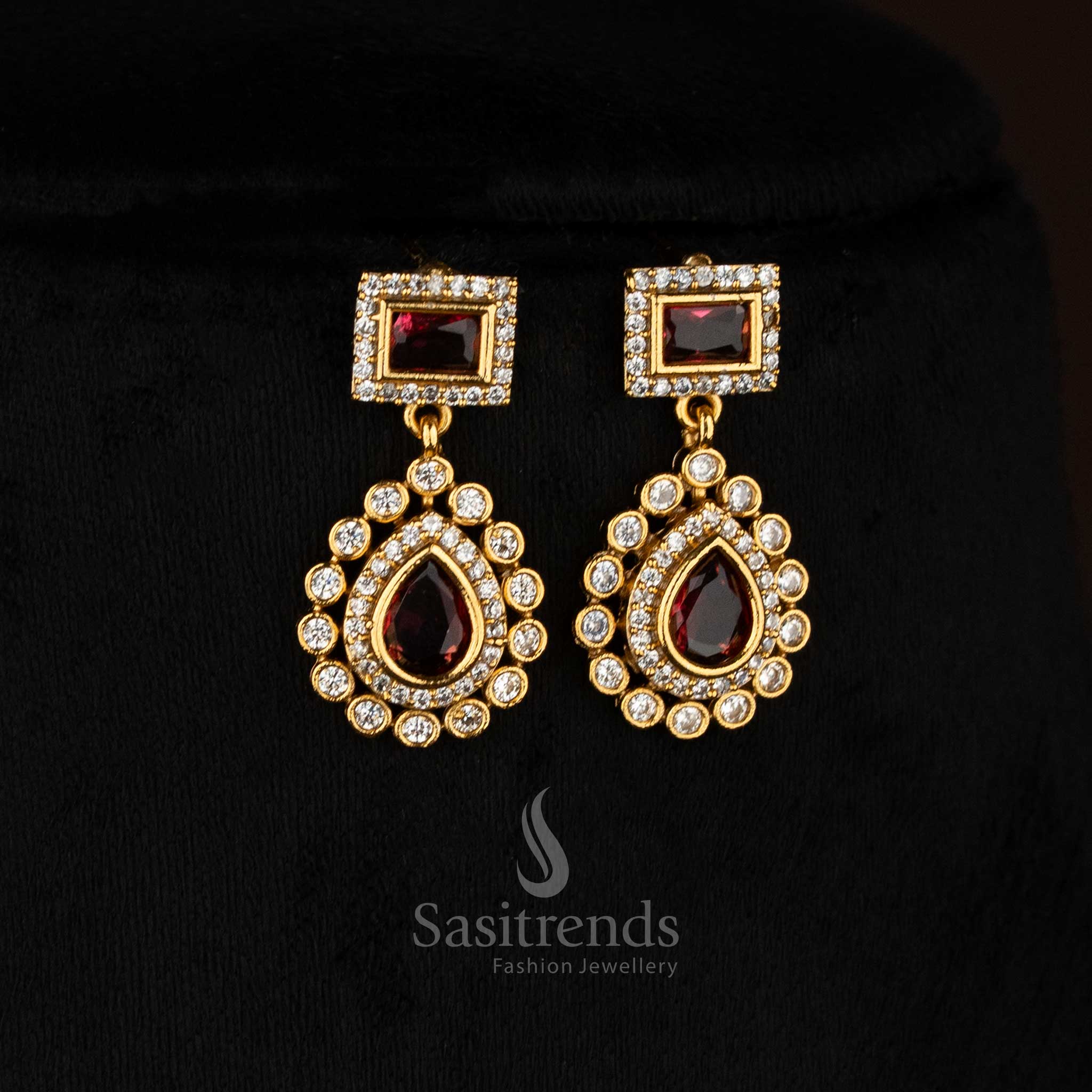 Regal red American Diamond matte gold plated teardrop rectangle motif earrings for stylish functions - Sasitrends