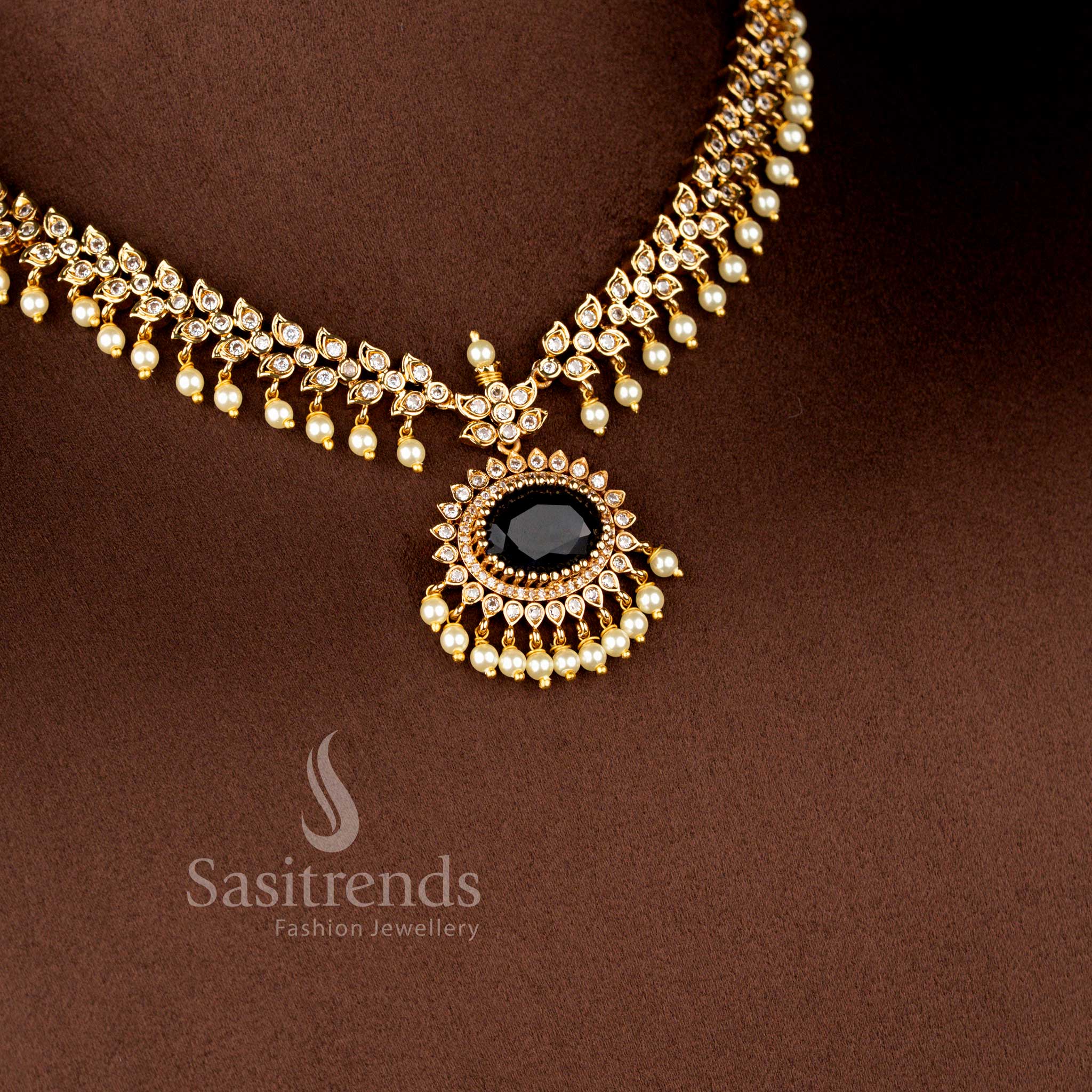 Close-up view of Matte Gold Plated American Diamond Oval Linked Necklace Set featuring cascading paisley motifs, pearl drops stones - Sasitrends