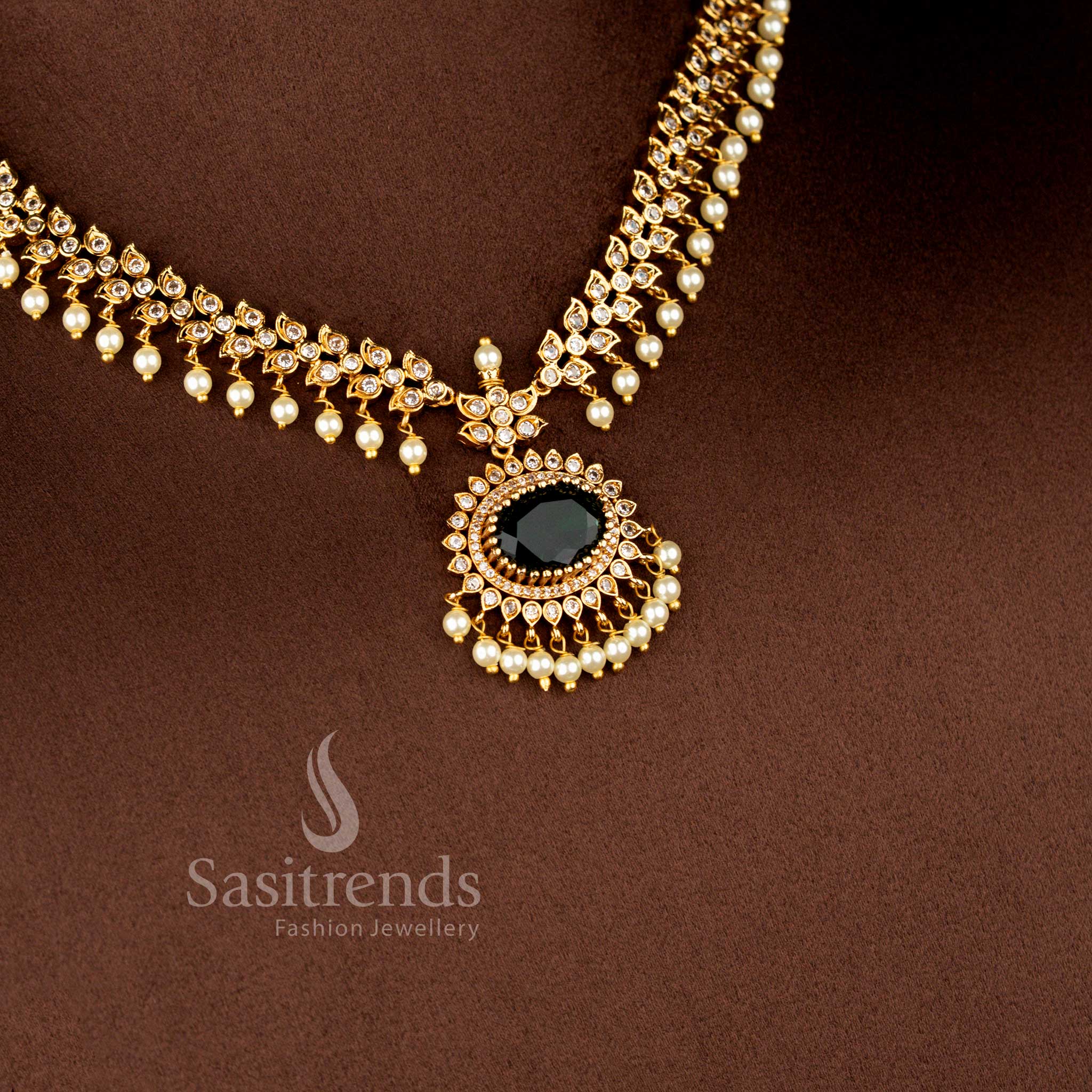 Close-up view of Matte Gold Plated American Diamond Oval Linked Necklace Set featuring cascading paisley motifs, pearl drops stones - Sasitrends