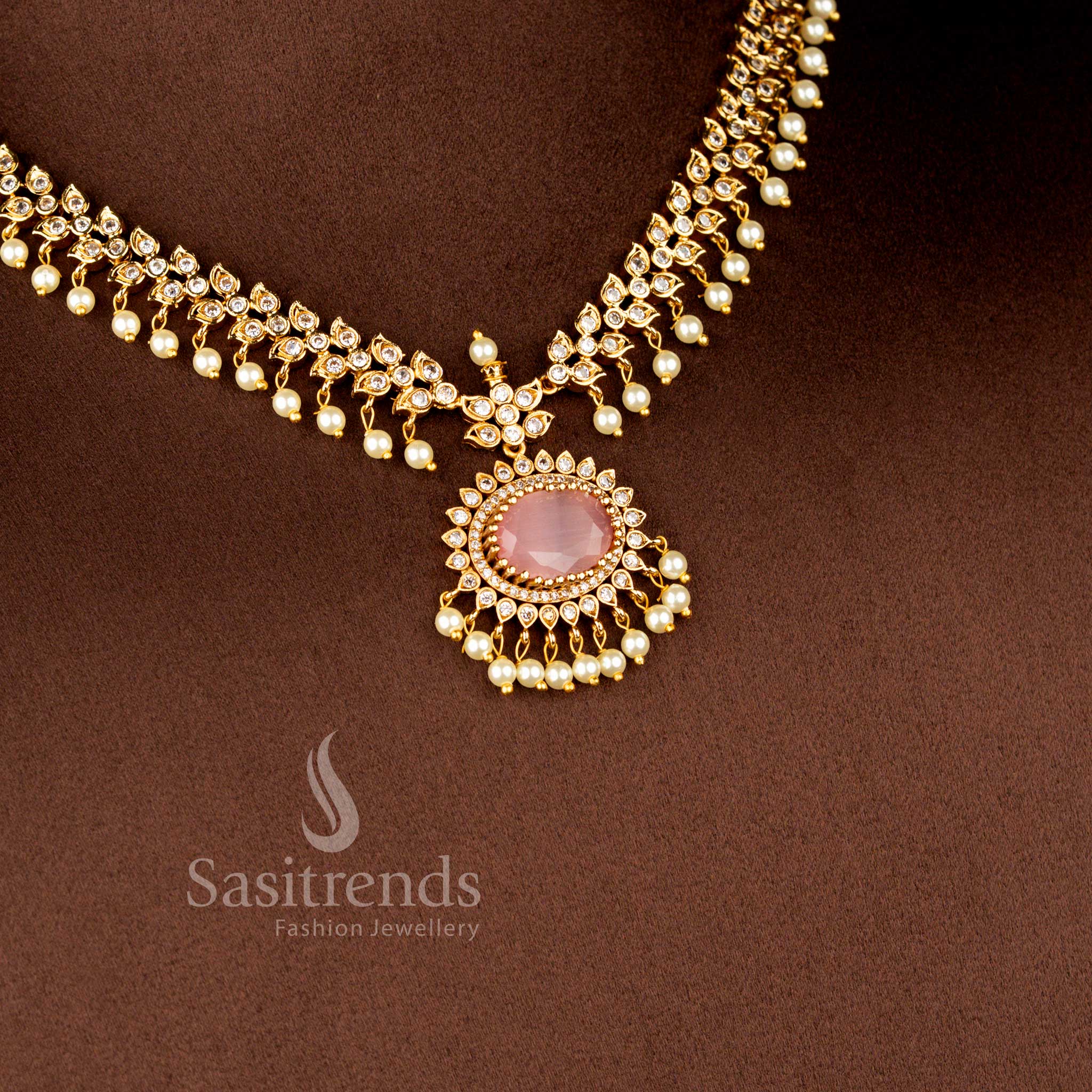 Close-up view of Matte Gold Plated American Diamond Oval Linked Necklace Set featuring cascading paisley motifs, pearl drops stones - Sasitrends