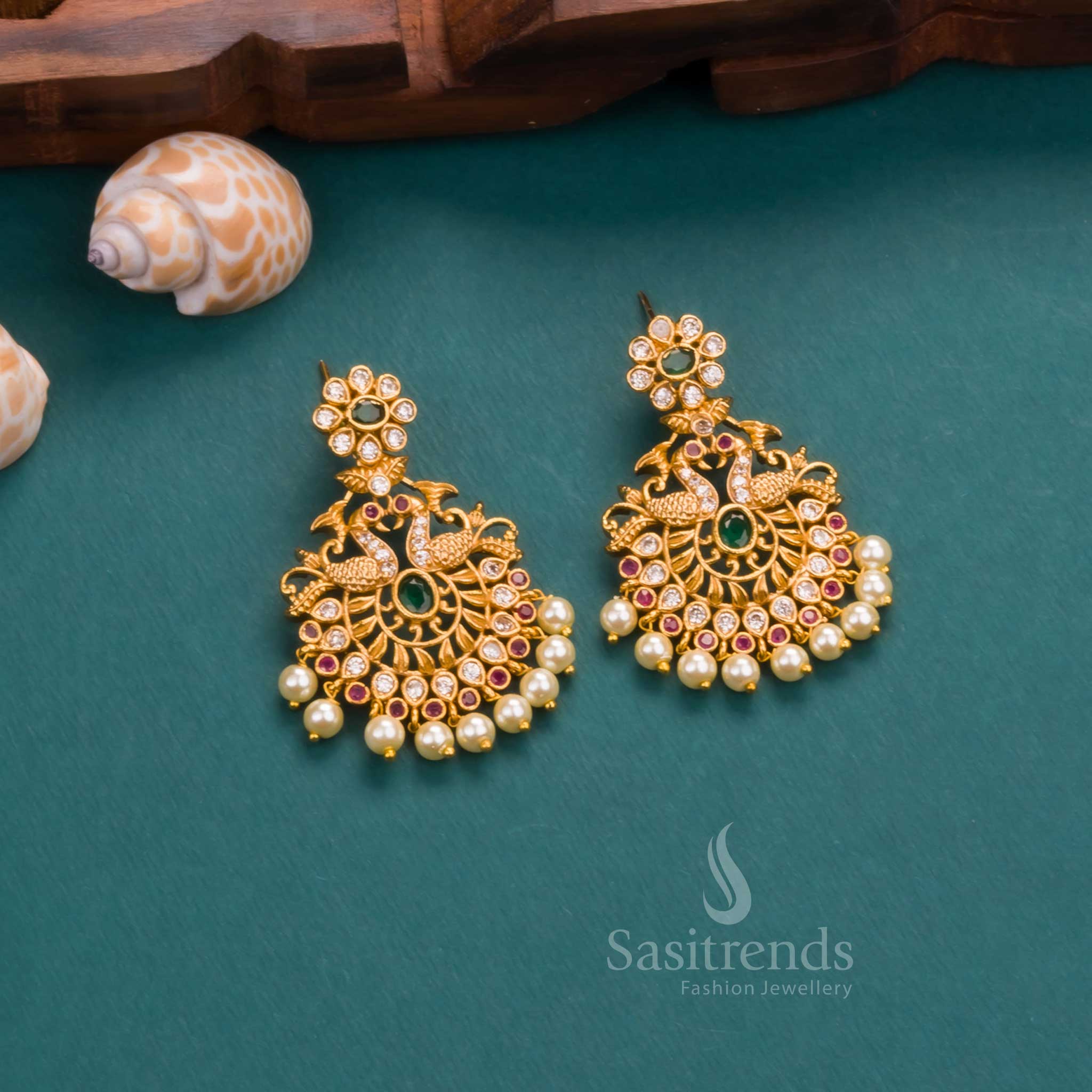 Vibrant matte finish temple-style in gold plating with multi-shade AD stones, adorned with pearl accents and festive earrings – a colourful statement piece from Sasitrends