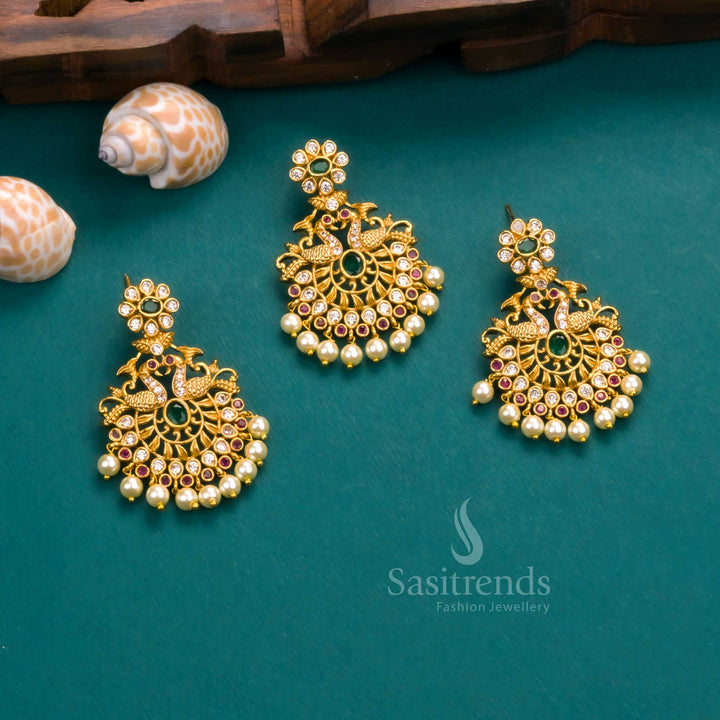 Grand matte gold plated temple peacock pendant with a vibrant mix of multi-coloured AD stones and elegant pearl drops, paired with matching earrings – perfect for occasion wear by Sasitrends