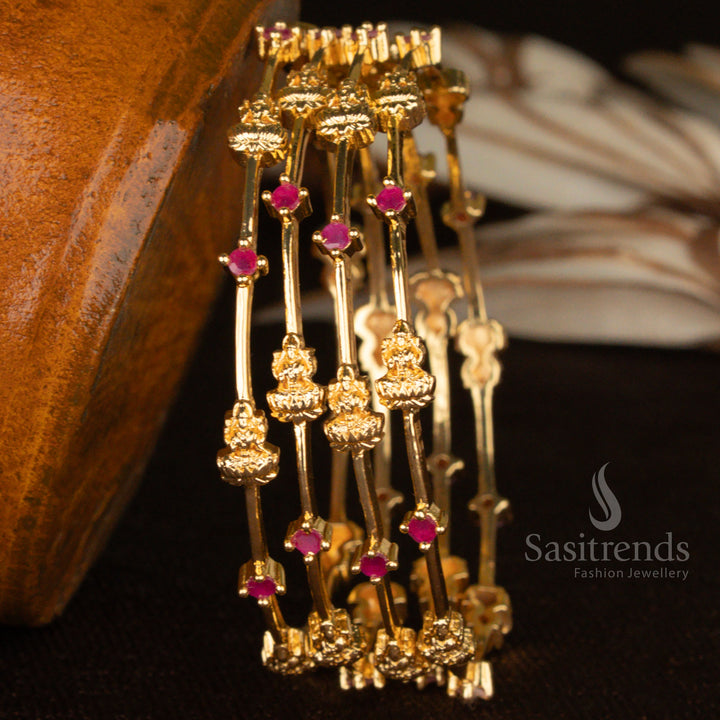 Heritage-style micro gold-plated Lakshmi bangles set, beautifully embedded with ruby stones and adorned with sparkling American diamonds for an opulent ethnic look - Sasitrends