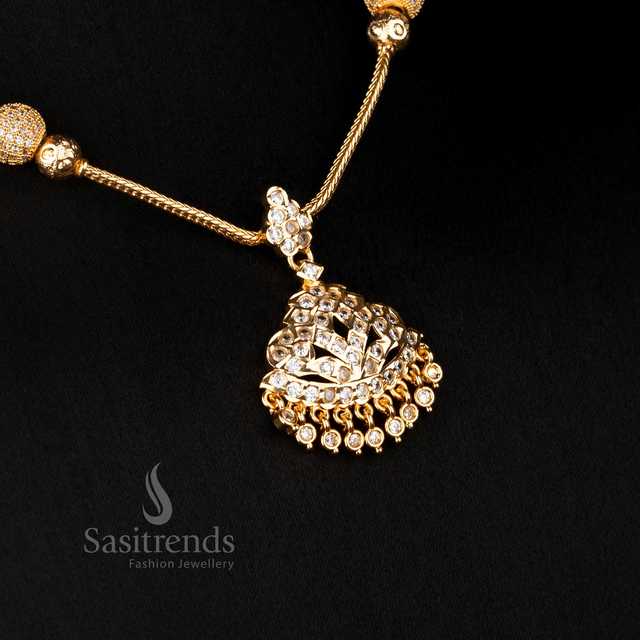 Temple style necklace featuring raised dome pendant and stone pattern structure