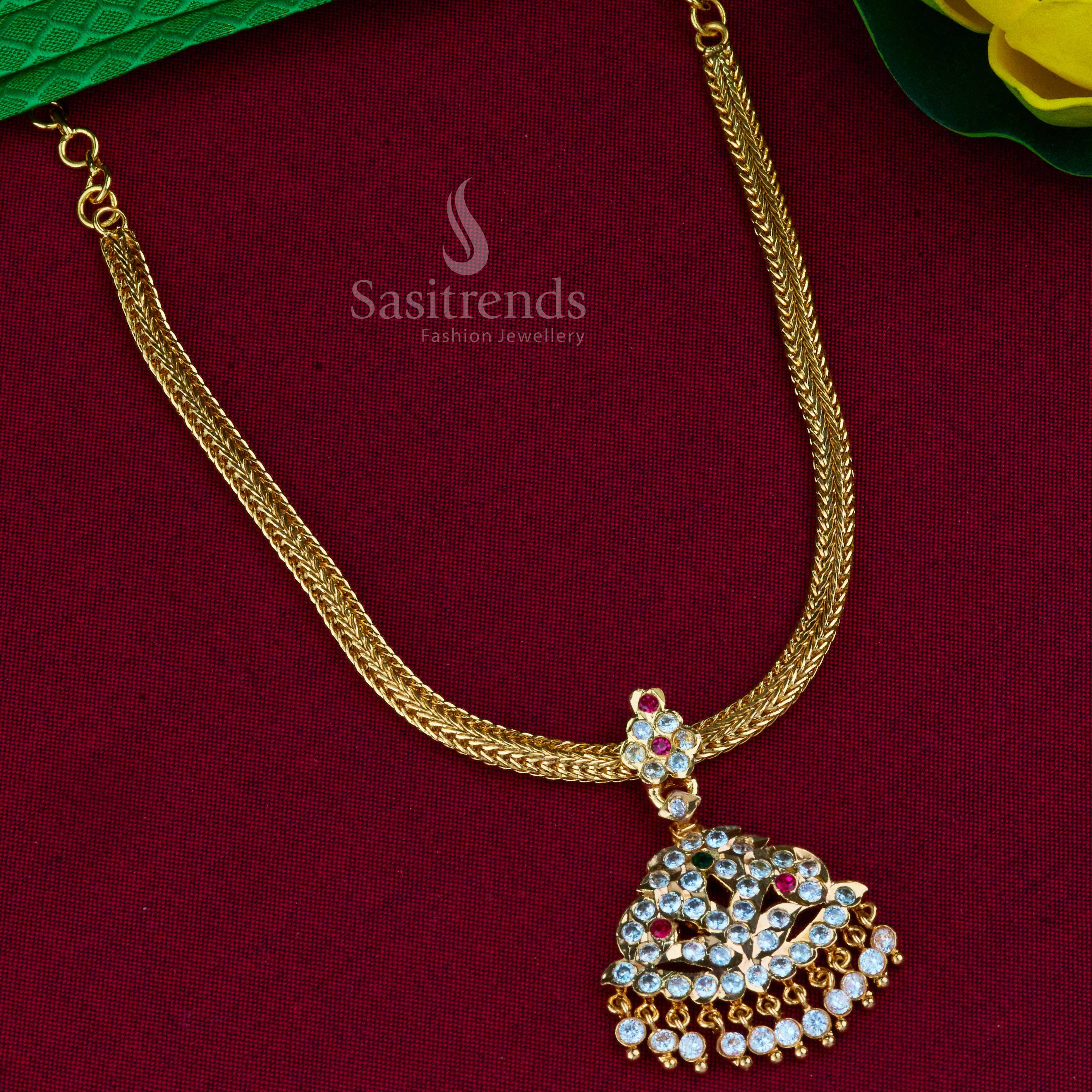 Captivating traditional Attigai pendant necklace, highlighted by its dazzling AD stones and lustrous micro gold plating, a statement piece from Sasitrends