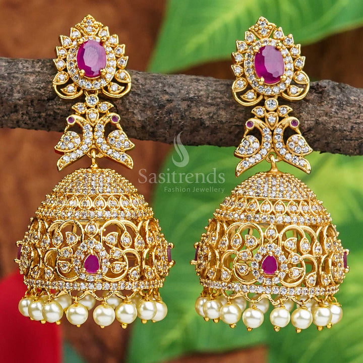 Temple matte finish peacock bridal jhumkas adorned with sparkling white and ruby AD stones, radiating traditional charm and cultural richness – ethnic jewellery style from Sasitrends