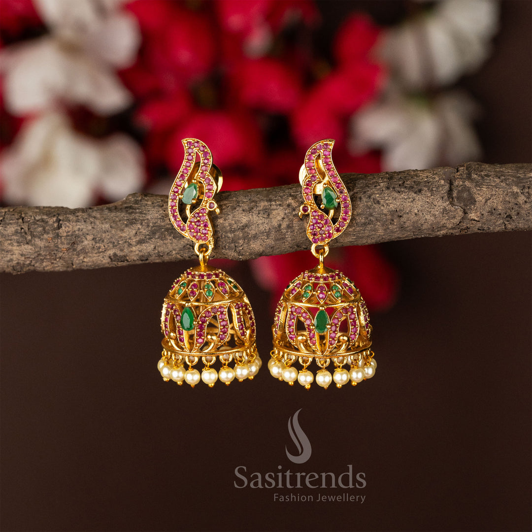 Traditional temple matte gold plated peacock jhumka earrings featuring ruby-green AD stones, reflecting rich cultural jewellery vibes - Sasitrends