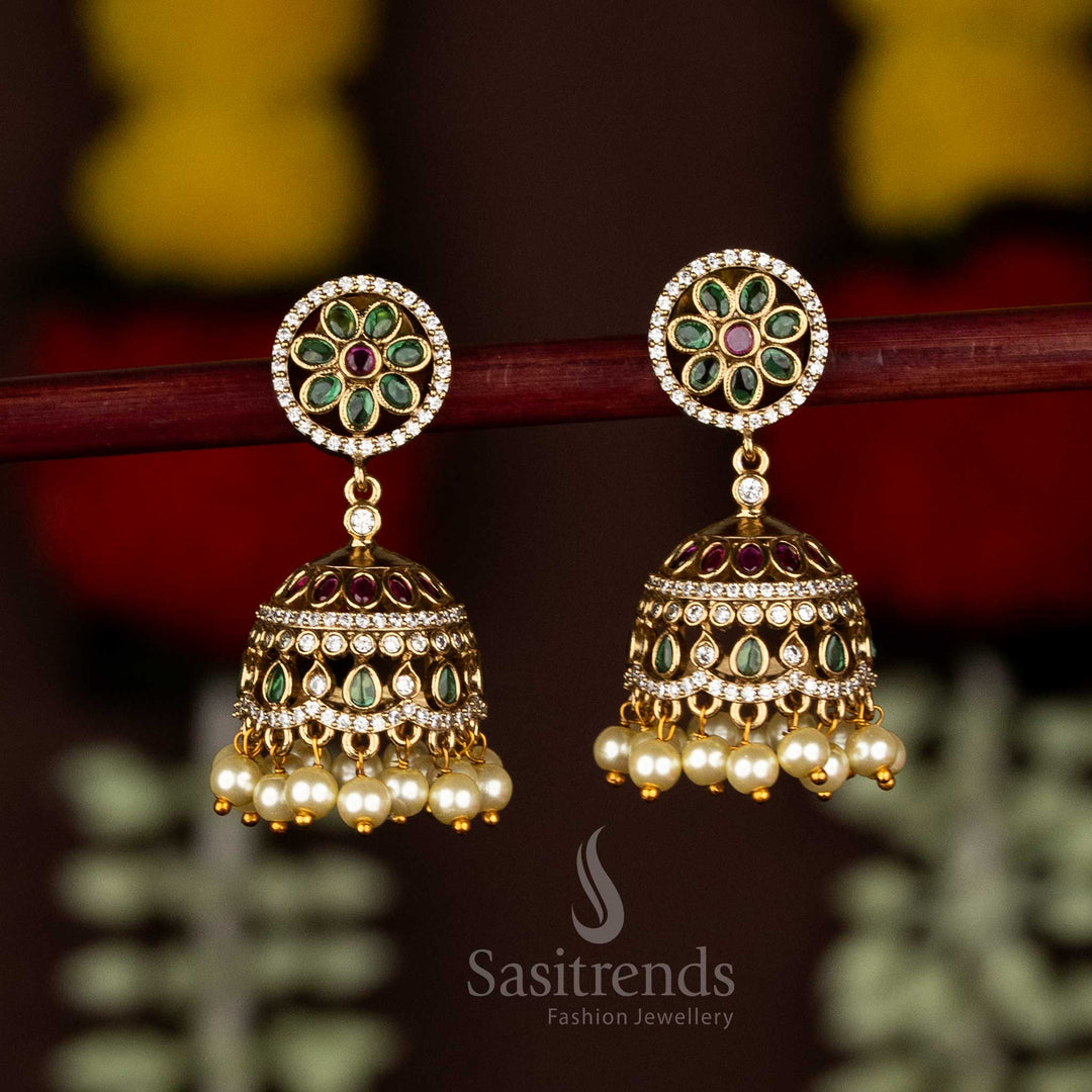 Sasitrends Matte Gold Plated AD Stone Emerald Floral Halo Jhumka Earrings with Pearl Drops