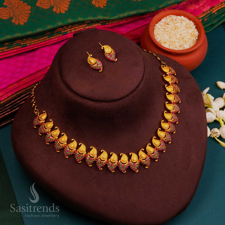 Ruby-green AD temple jewellery in matte gold with South Indian goddess-inspired design, radiating festive opulence and timeless spiritual beauty by Sasitrends