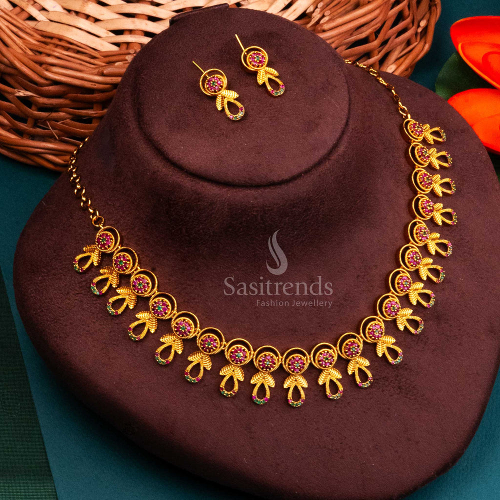 Regal ruby-green flower temple jewellery with AD accents in matte gold, highlighting South Indian festive vibes and spiritual sheen by Sasitrends