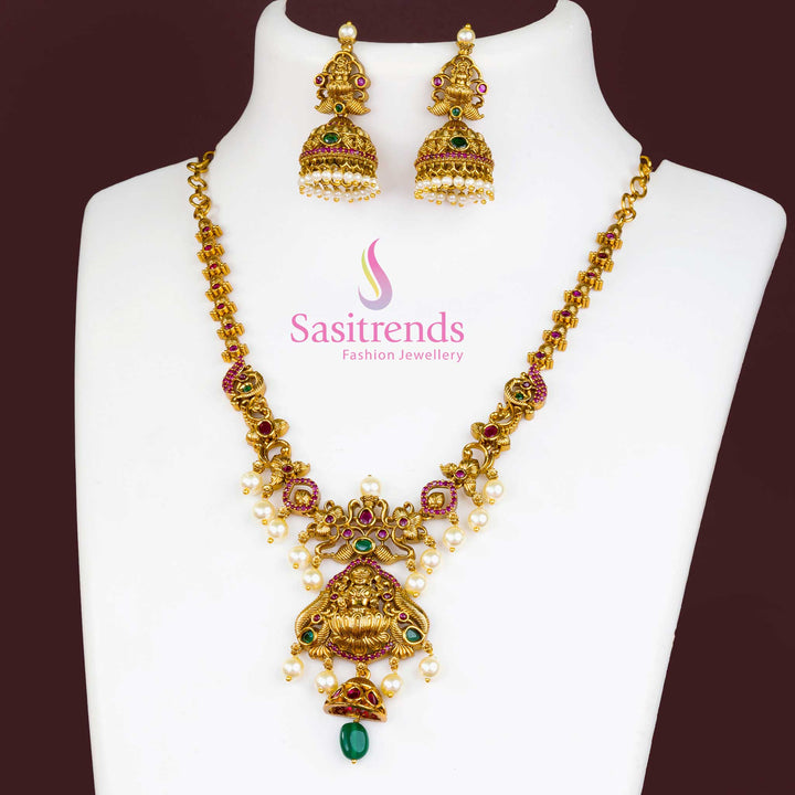 Exquisite Temple Matte Gold Plated Ruby Green Lakshmi Designer Jewellery Set With Floral Motif Pendant, AD Stones And Elegant Matching Earrings – Perfect For Traditional Occasions – Sasitrends