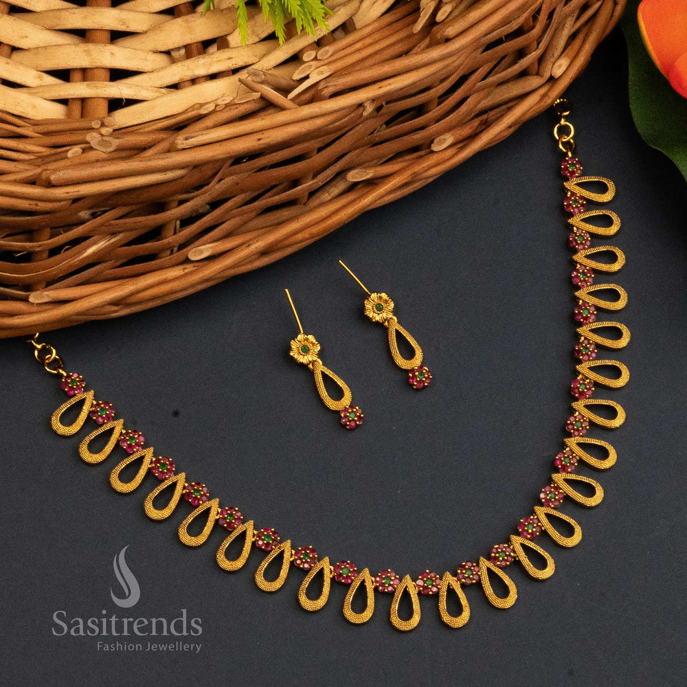 Ruby Green Temple Jewellery Set With Matte Gold Finish, AD Stones, Ornate Centrepiece, And Classic Jhumkas – Devotional Beauty With Cultural Elegance – Sasitrends