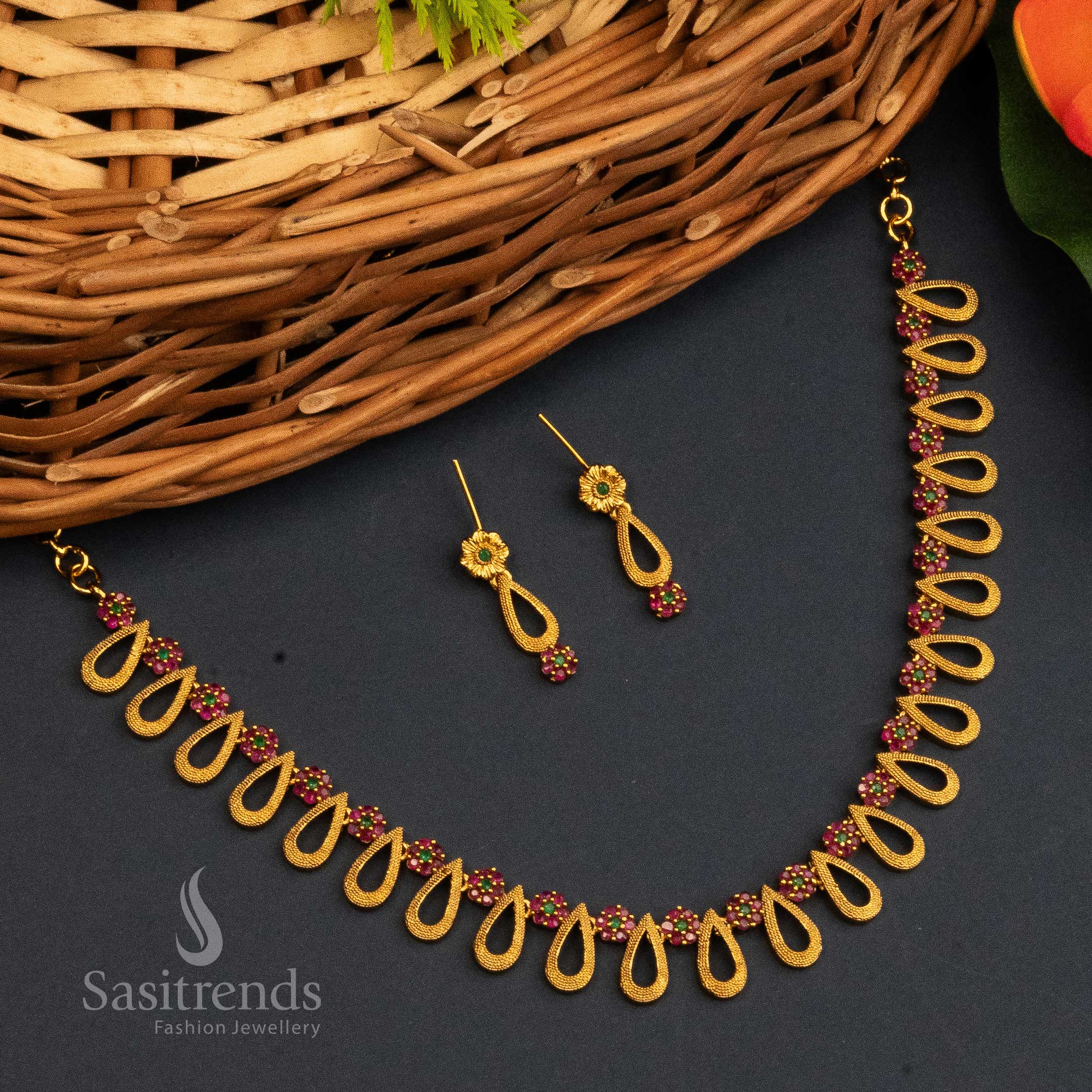 Ruby Green Temple Jewellery Set With Matte Gold Finish, AD Stones, Ornate Centrepiece, And Classic Jhumkas – Devotional Beauty With Cultural Elegance – Sasitrends
