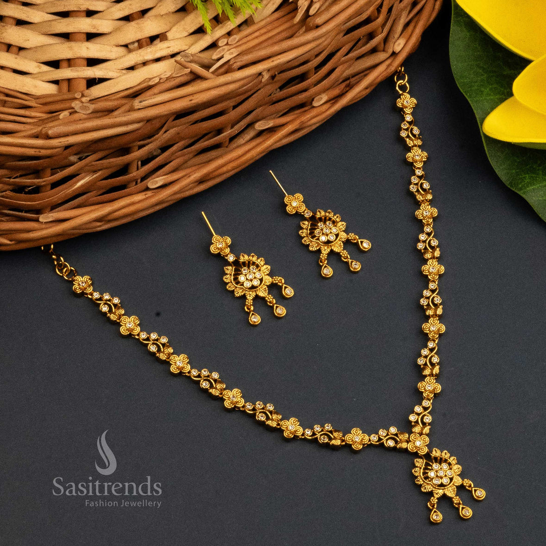 Elegant White Stone Matte Gold Plated Temple Jewellery Set Adorned With Shimmering American Diamonds, Simple Floral Pendant And Sophisticated Earrings – Sasitrends