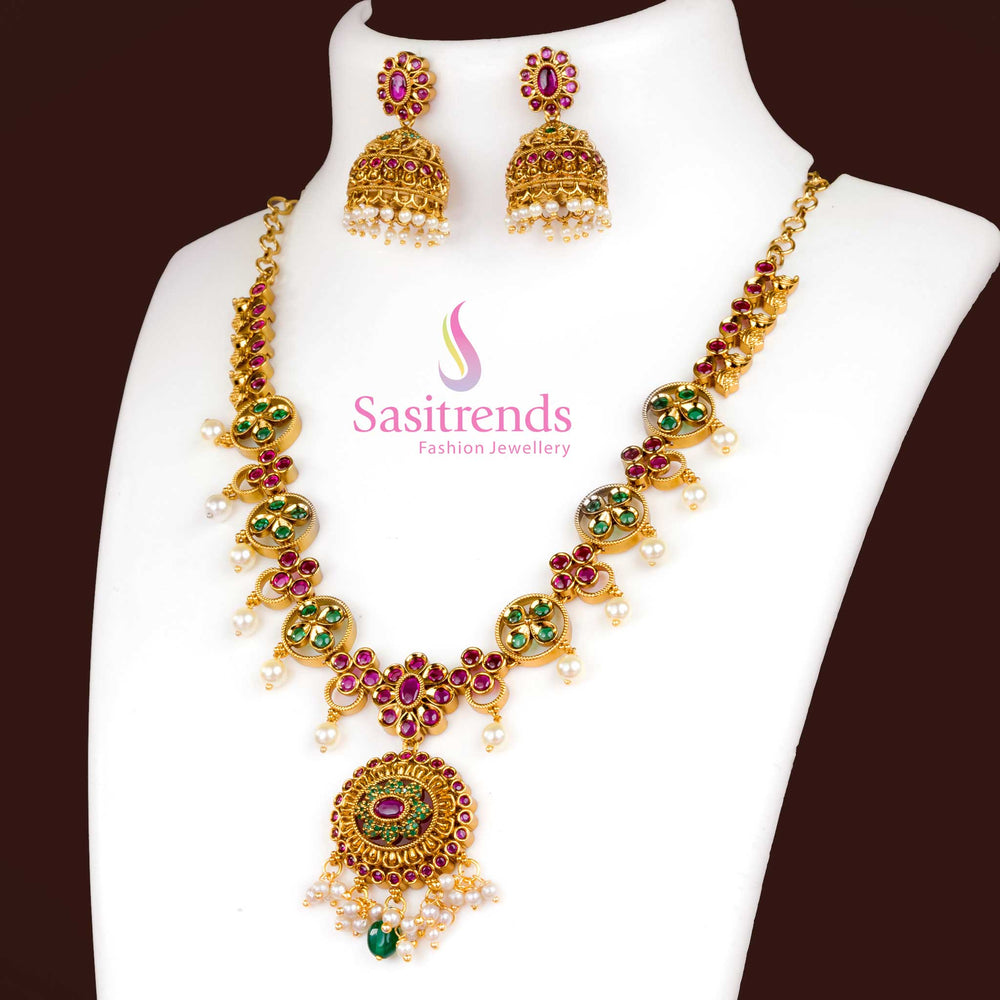 Ruby Green Matte Gold Finish Floral Pendant Jewellery Set With Stunning AD Highlights, Matching Jhumkas, And Traditional Appeal For Celebrations And Weddings – Sasitrends