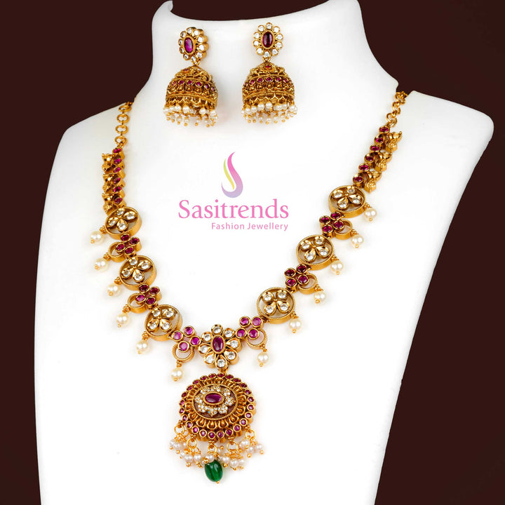 Elegant White Ruby Matte Gold Plated Jewellery Set With Floral Pendant Design, American Diamond Accents, And Graceful Jhumkas – Ideal For Traditional Occasions And Festivals – Sasitrends
