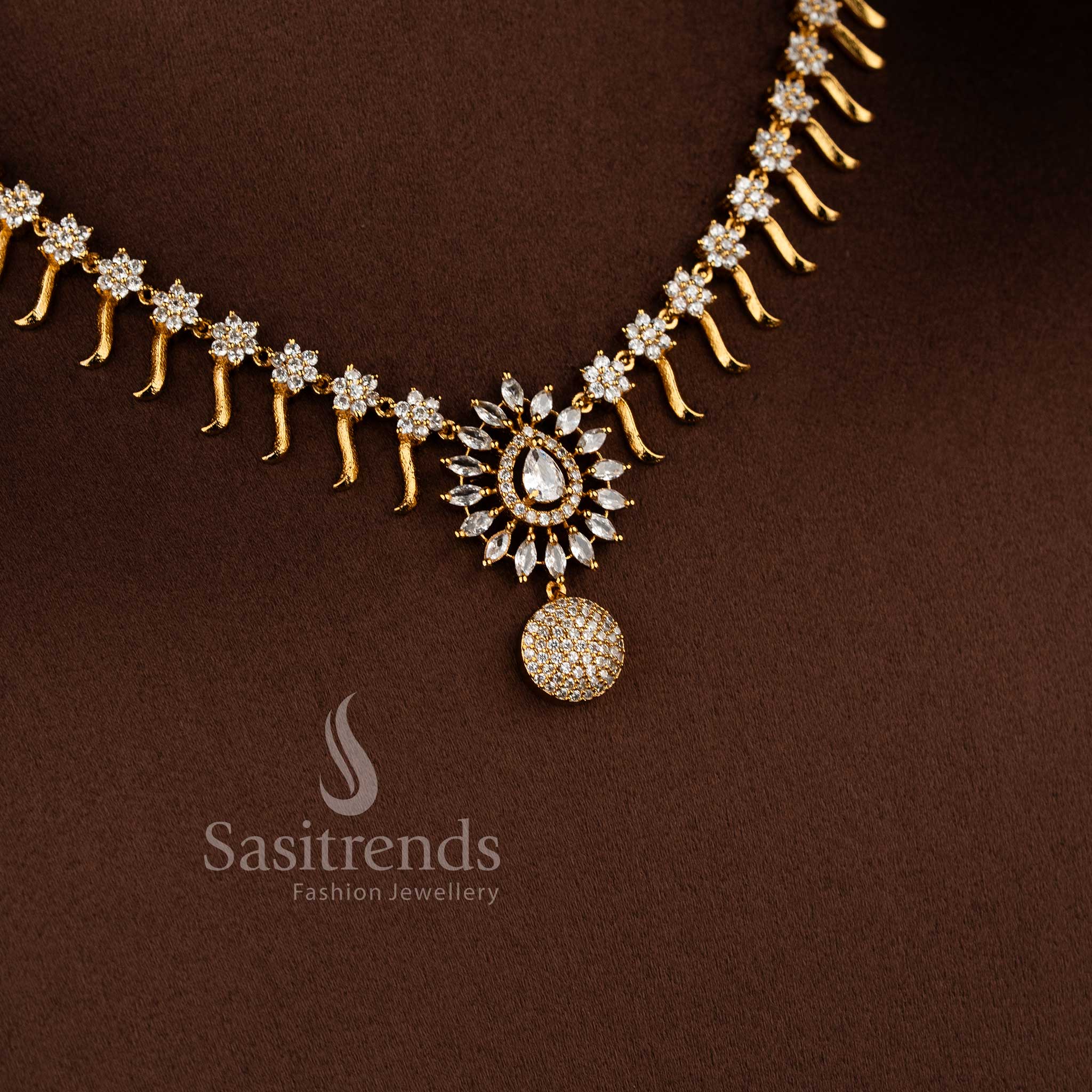 Elegant matte gold floral necklace set with white AD stones for party and festive wear.