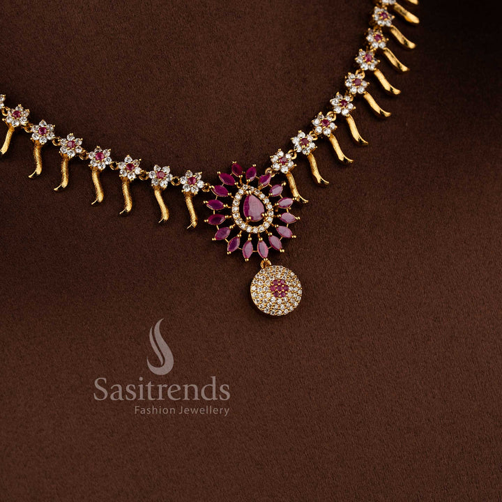 Elegant matte gold floral necklace set with white and ruby AD stones for festive and party wear